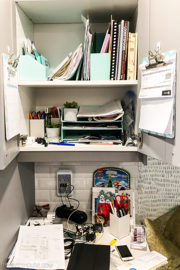 An office shelf filled with loose paper.