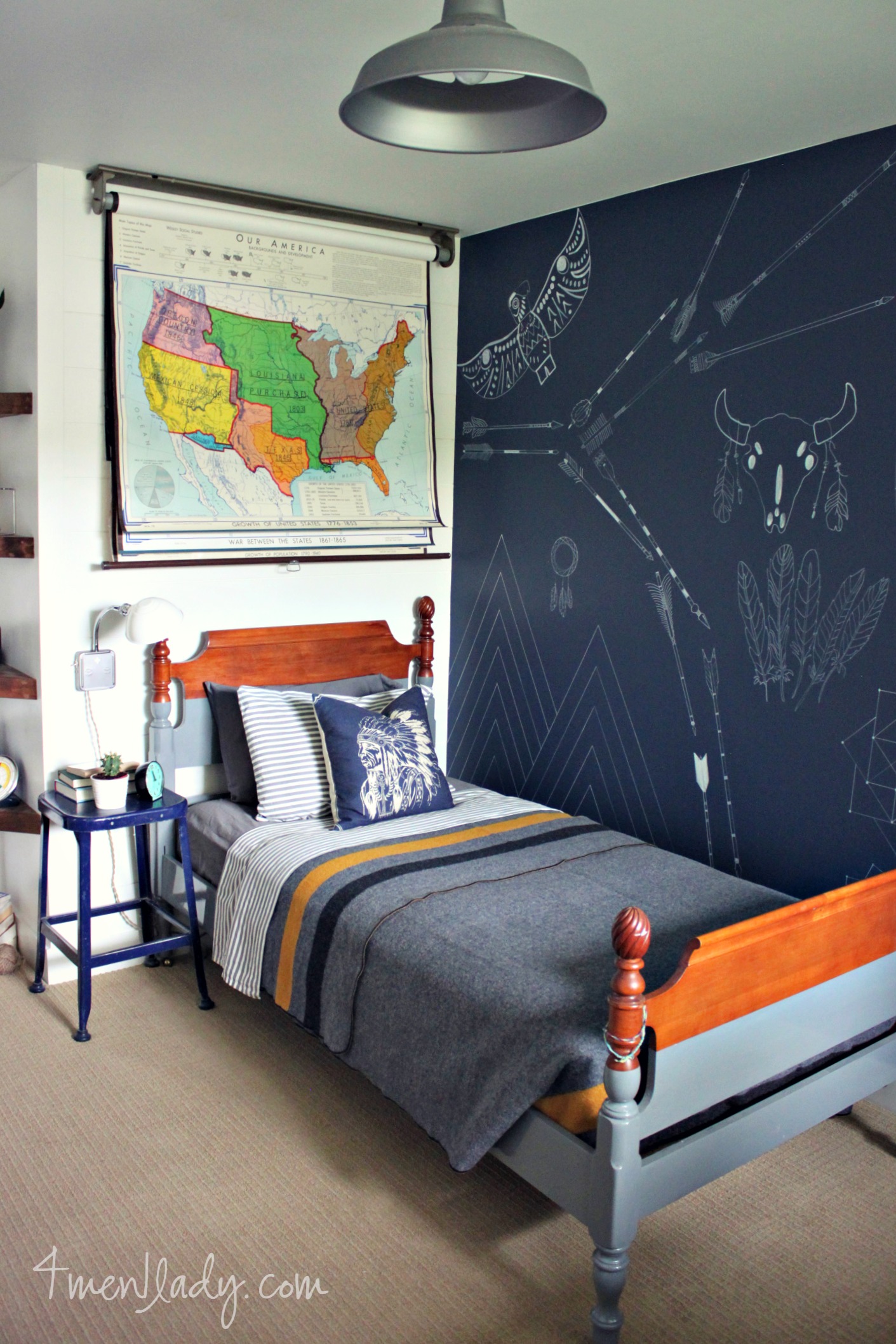 There is a map on the wall and a chalkboard wall beside the bed.