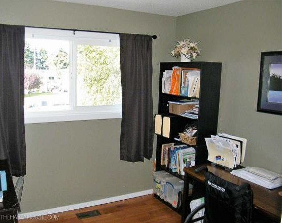The room before with a small desk and window painted grey.