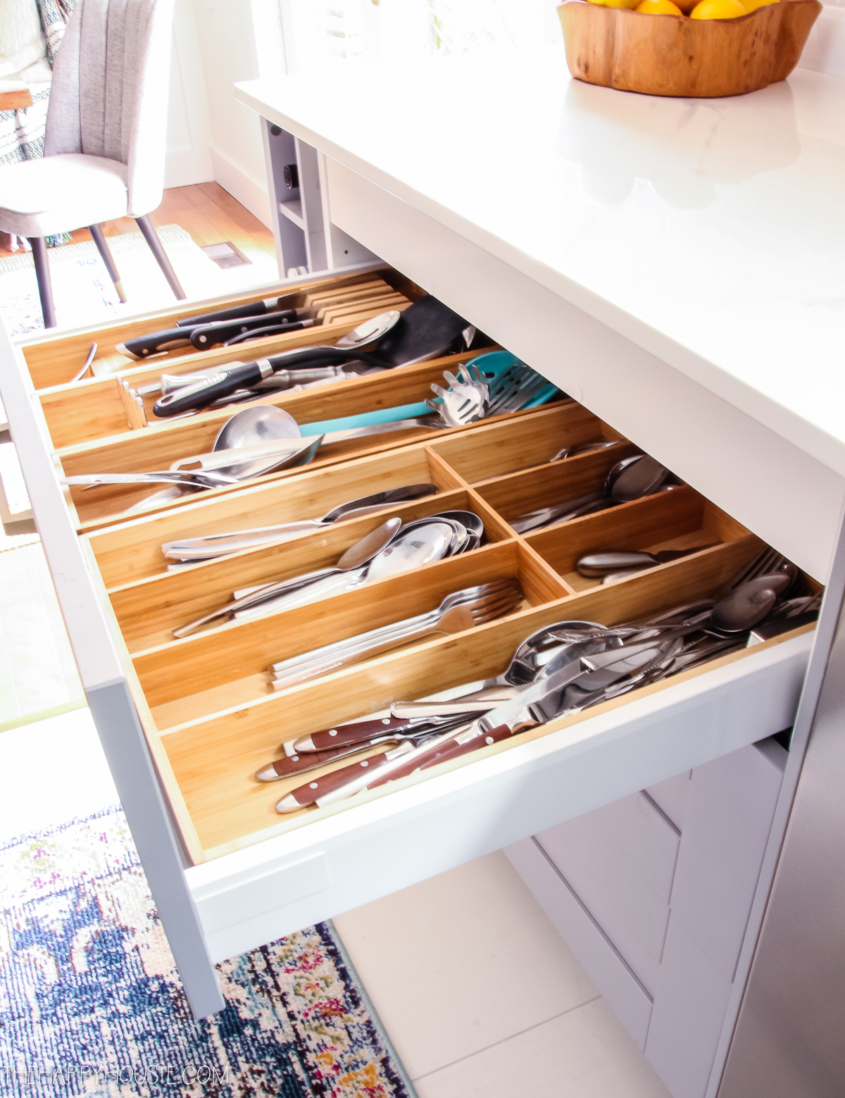 A wooden cutlery tray in the drawer in the kitchen.