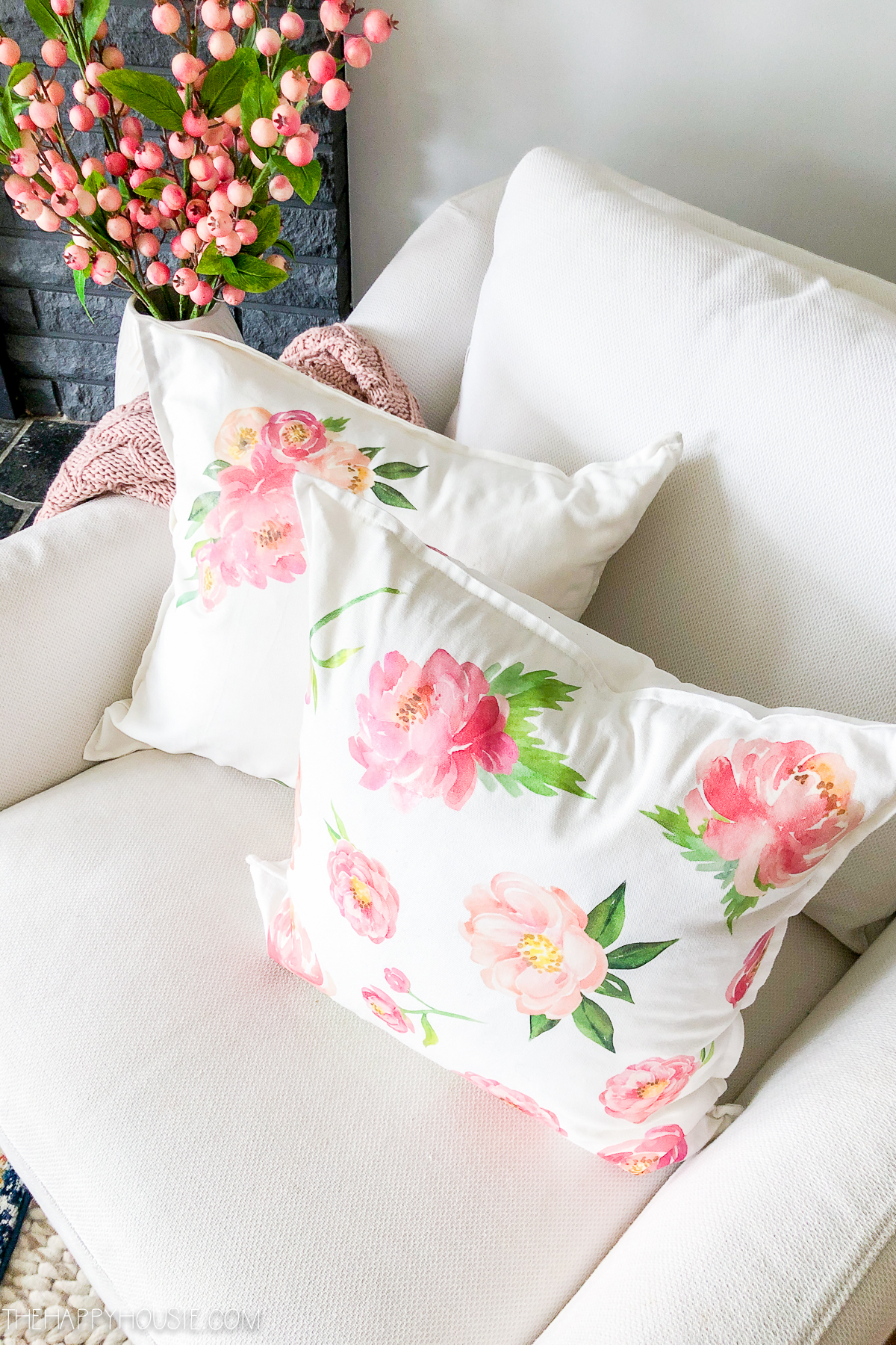 The pretty florals on the throw pillows on the armchair.