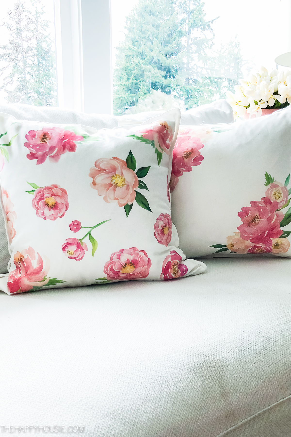 Floral throw pillows with pink flowers.