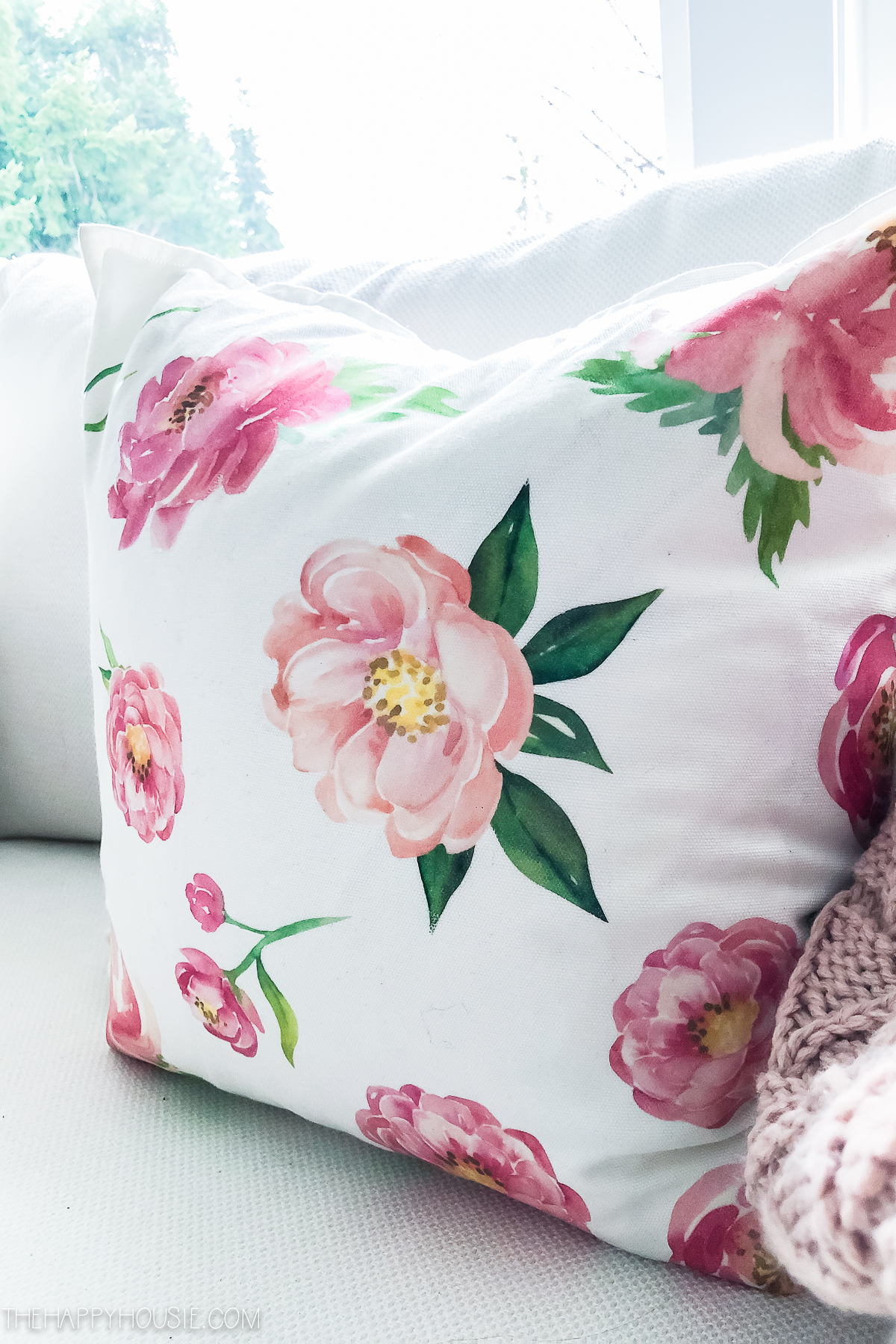 Pink flowers on a white pillow.