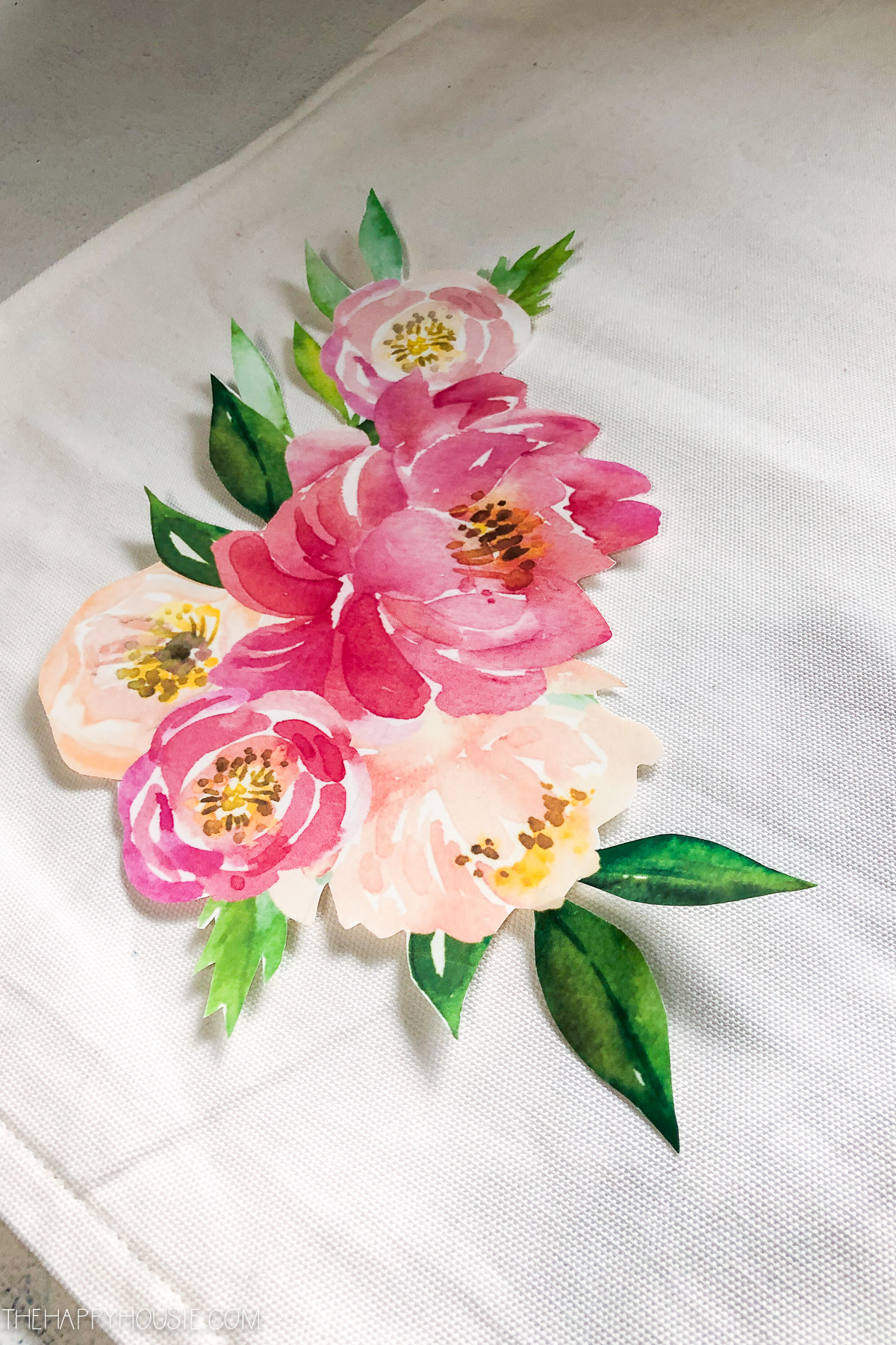 The floral design cut out and on the fabric.