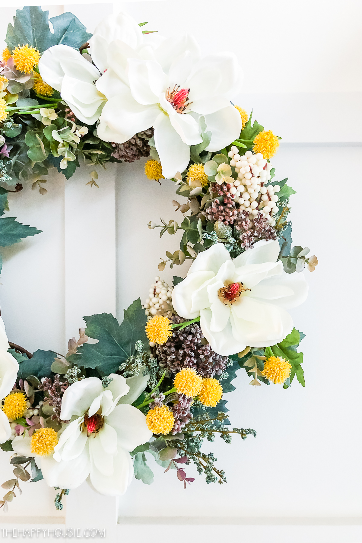 There are white berries on the wreath.