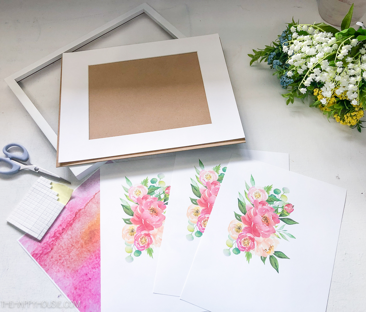 Watercolor printables on the table beside scissors.