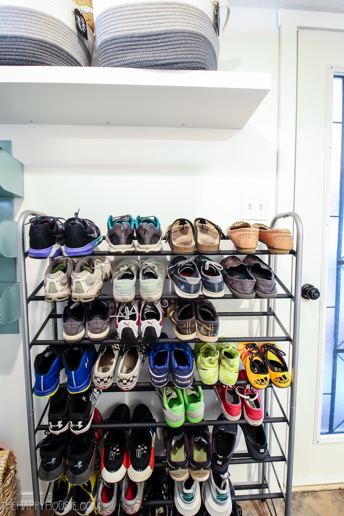 All the shoes lined up on the rack.