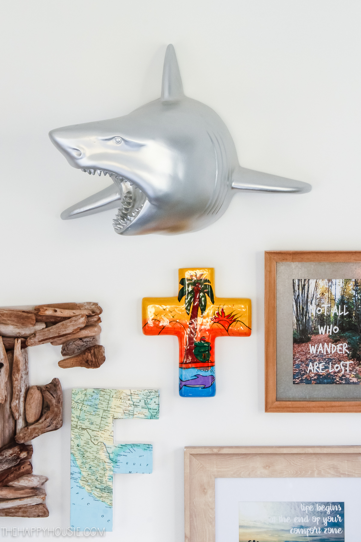 A large silver shark is on the wall.
