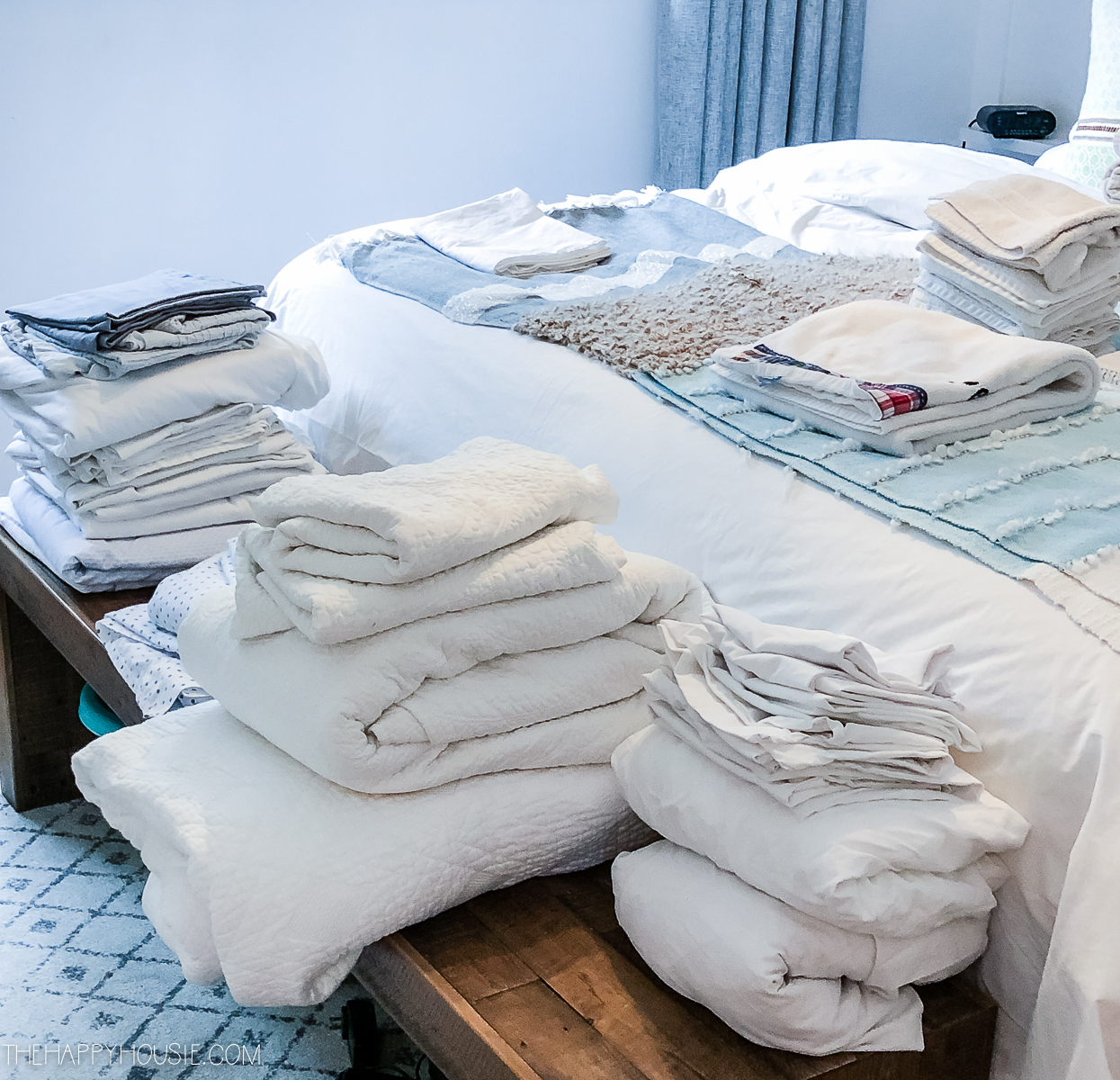 Sorting all the linen in piles on the bed.