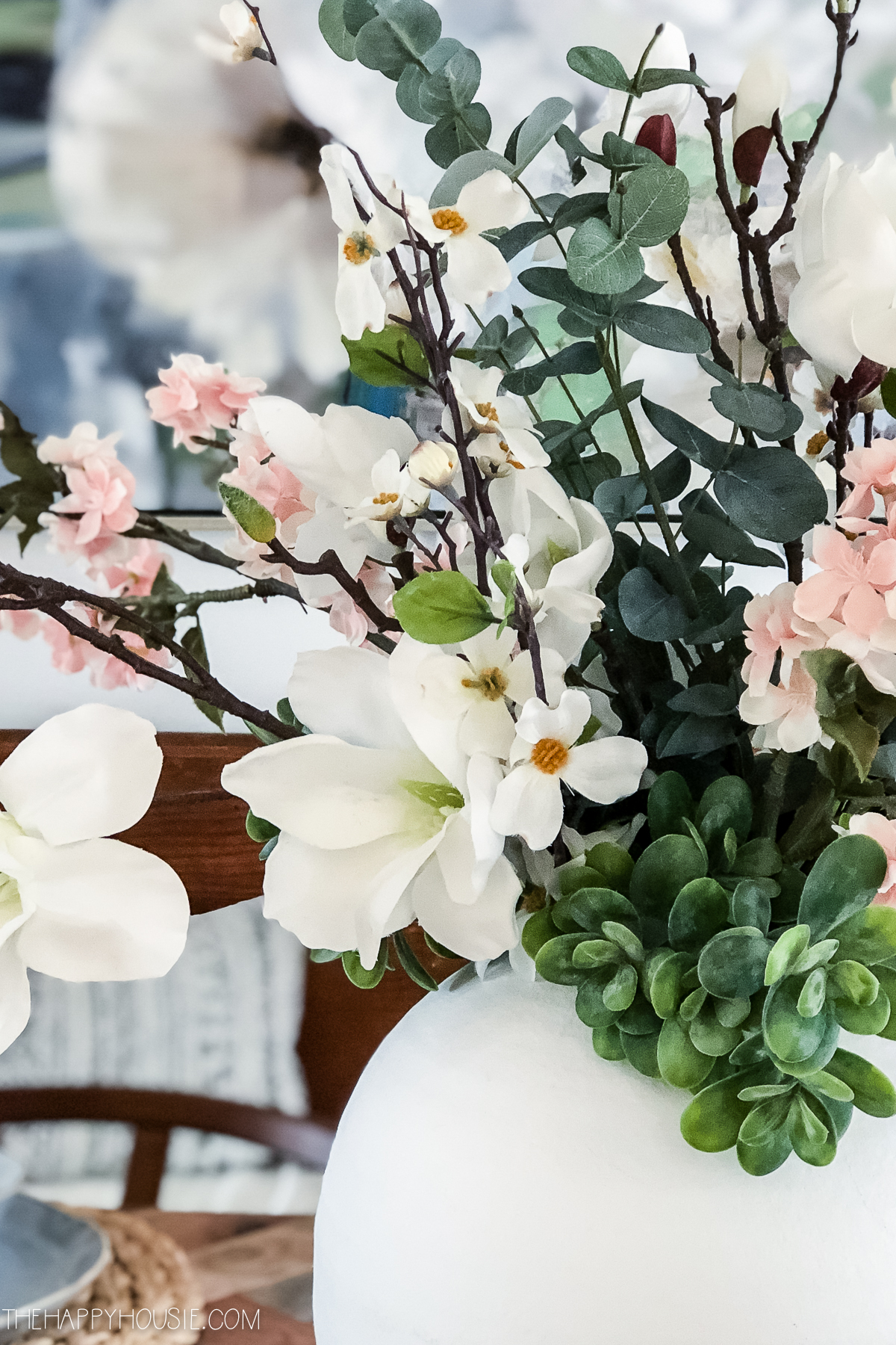 White, pink and green florals in the vase.