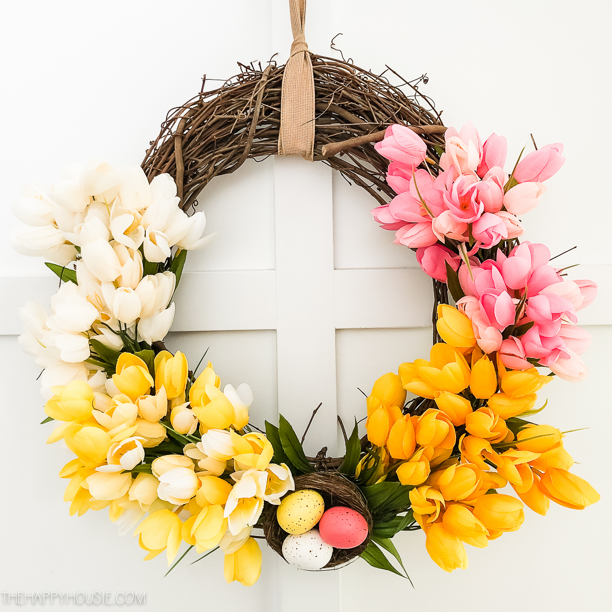 Pink, white, yellow tulips on the wreath.