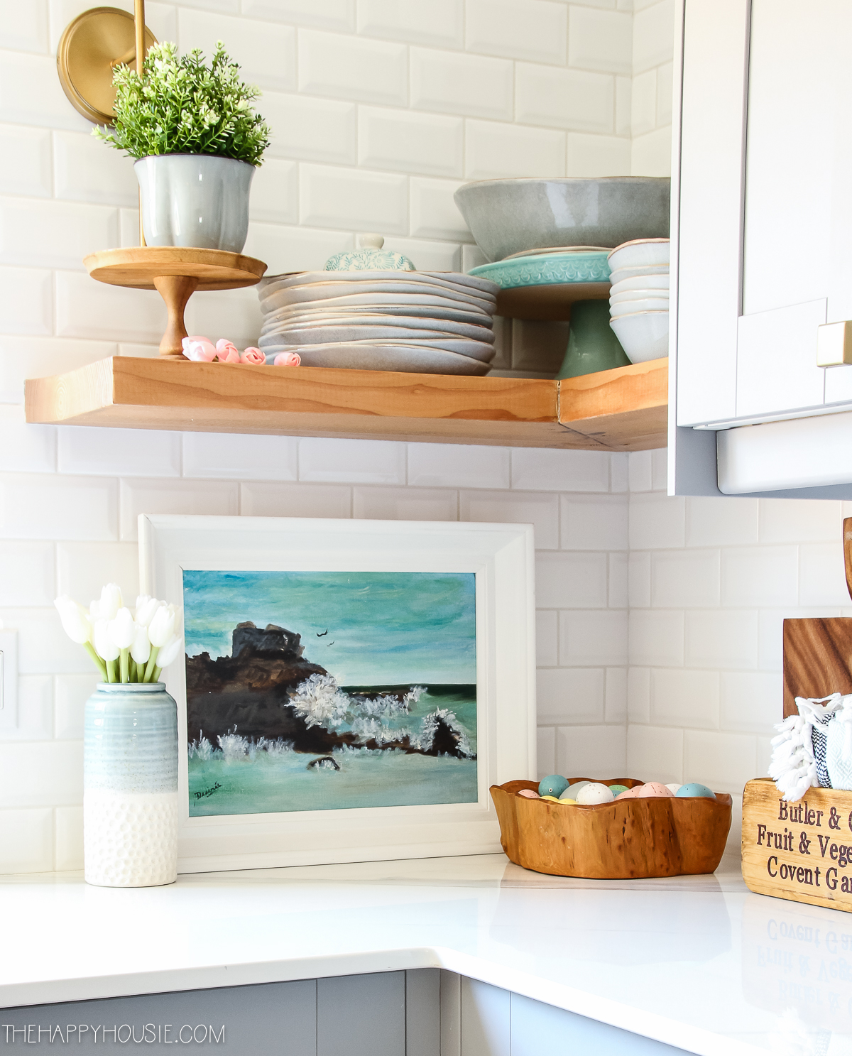 A small watercolour picture is in the kitchen by the shelves.