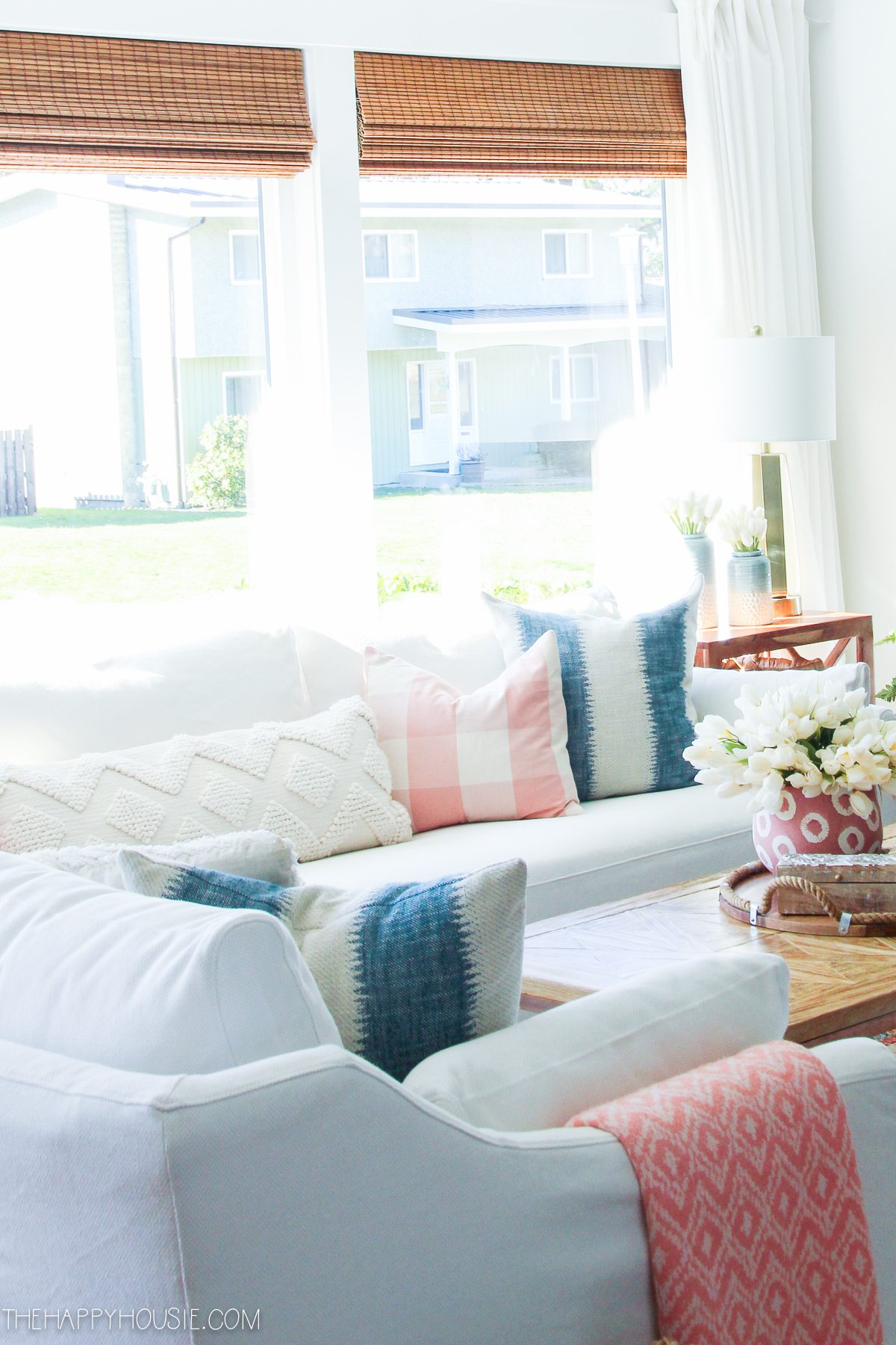 Blue, pink and white throw pillows on the couch.