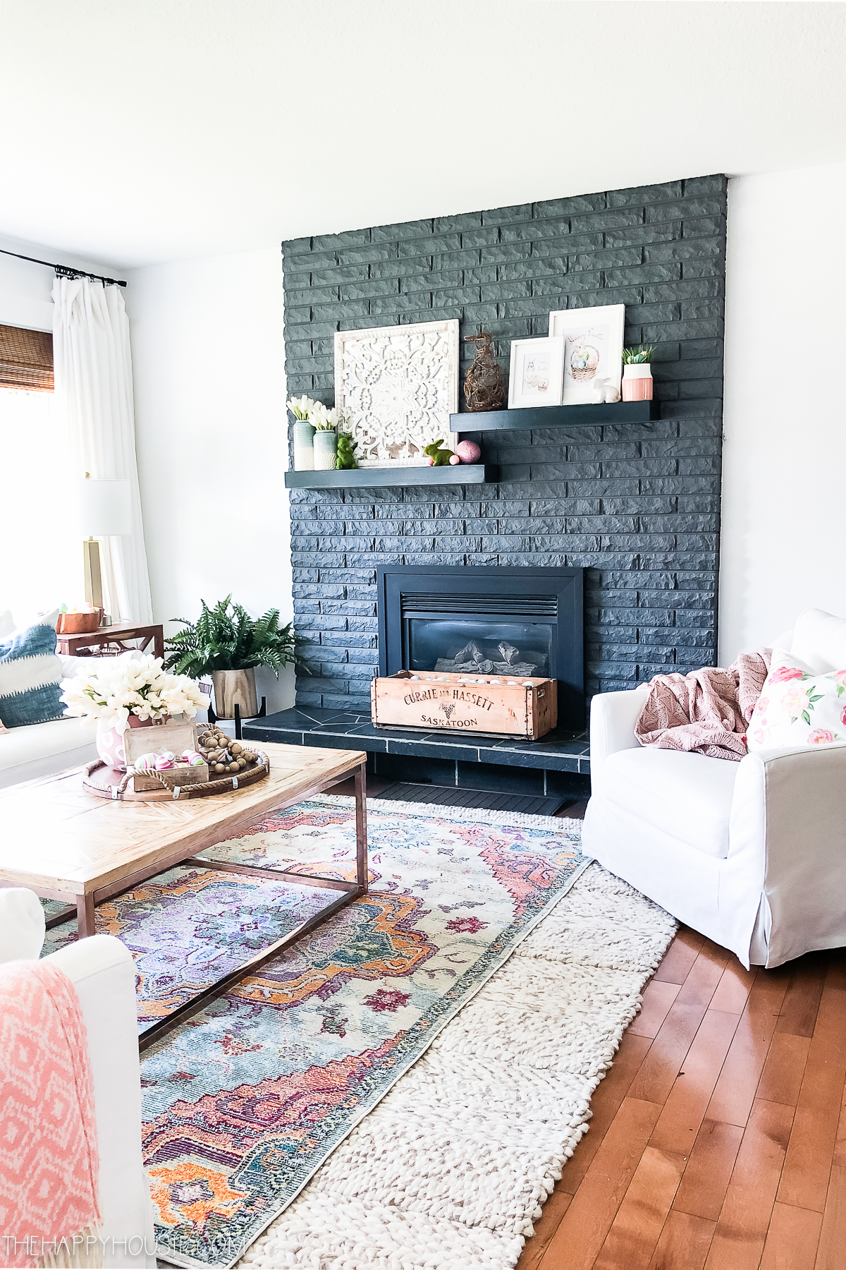Soft living room colours with a gray painted fireplace brick.