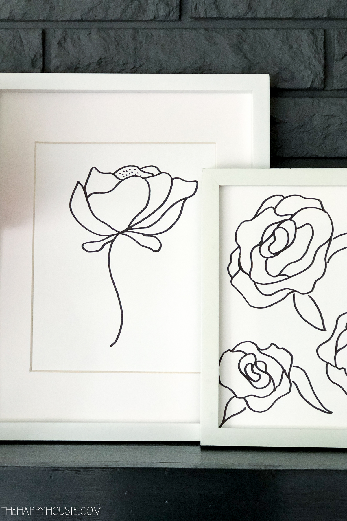 The white framed peony line drawings are on the mantel.