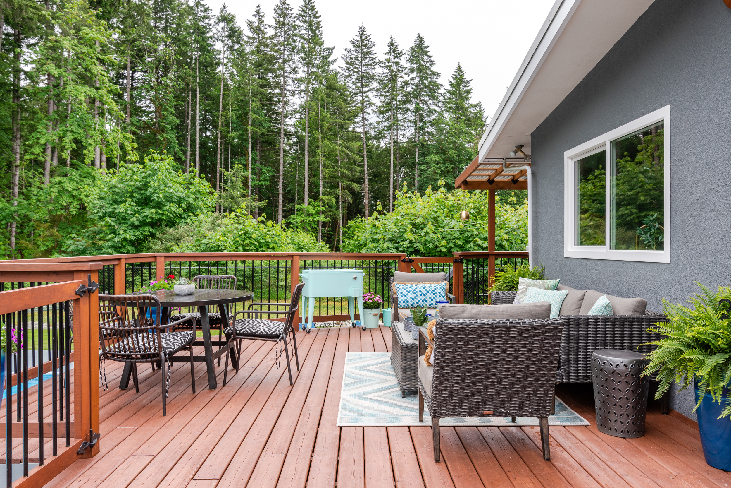 A backyard deck with the forest all around.