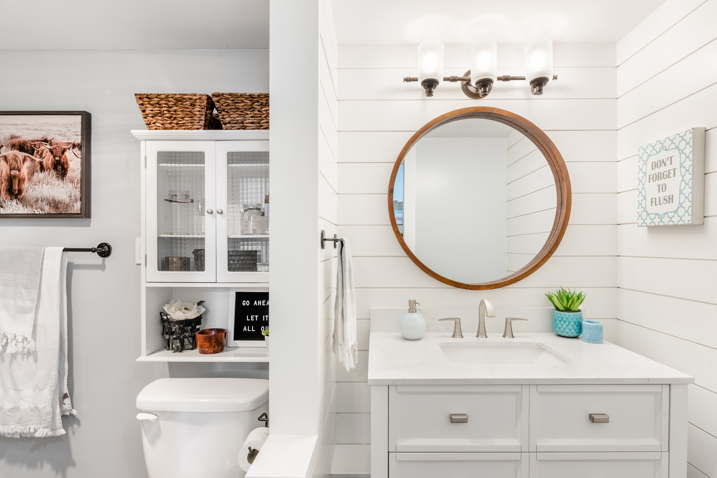newly updated bathroom with white shiplap feature walls around the vanity