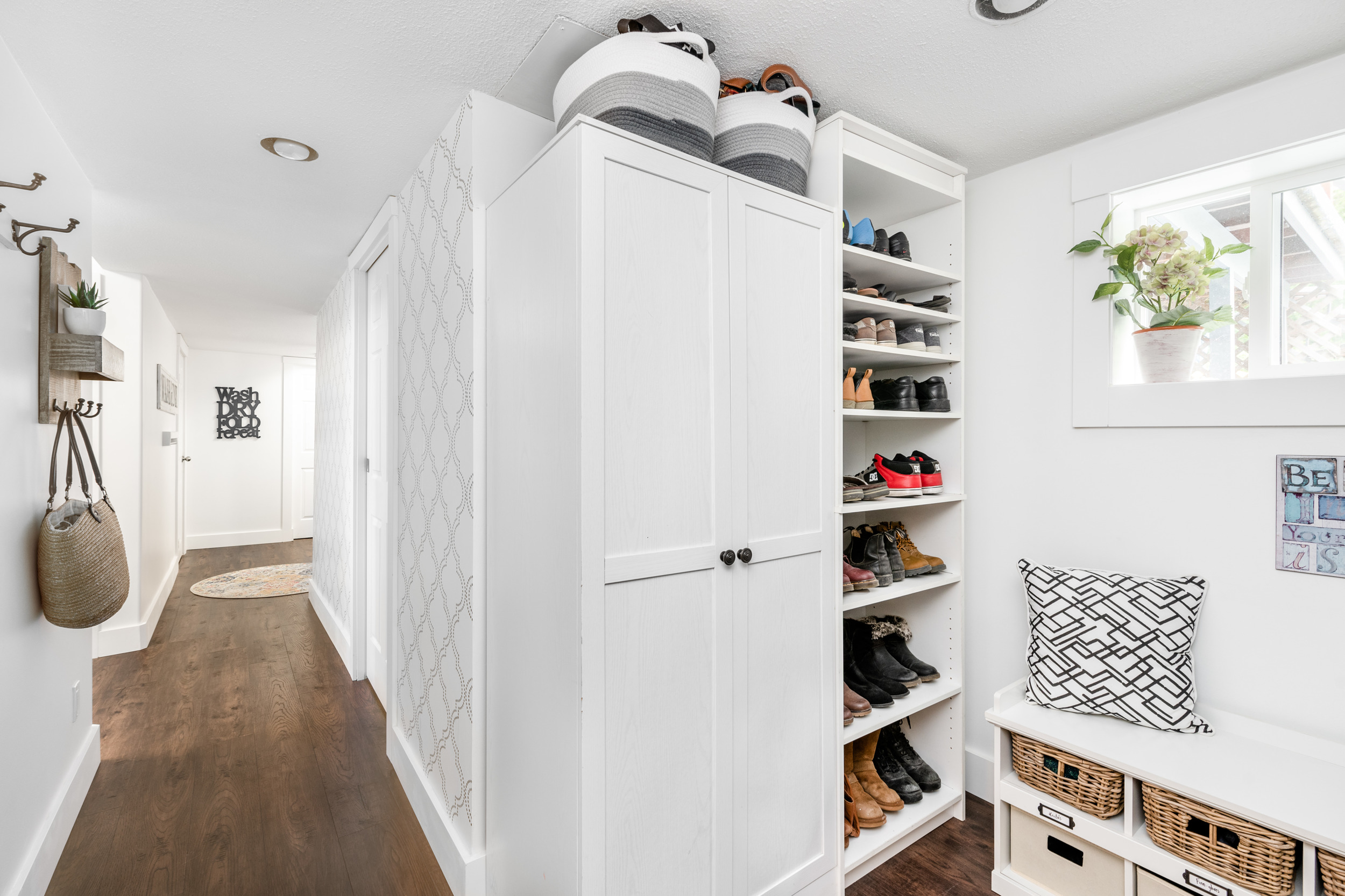 White built ins holding shoes.