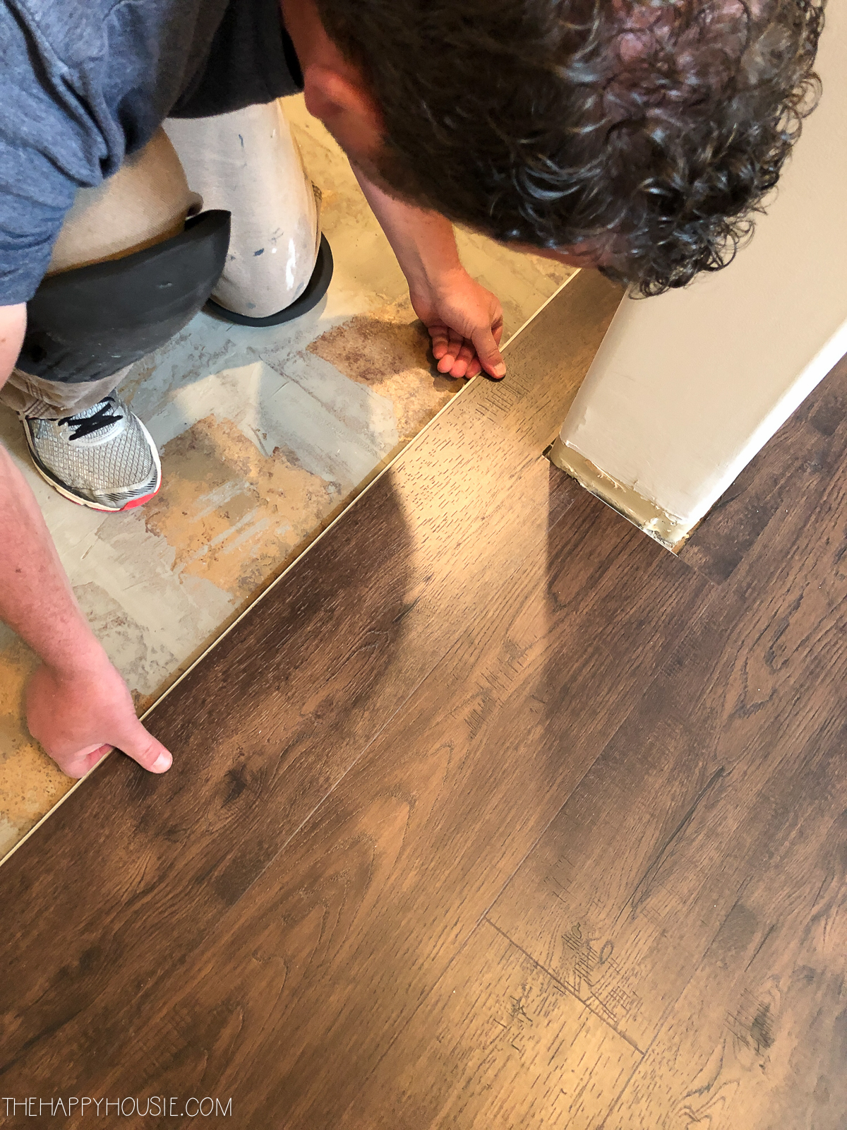 Cutting the flooring around the corners of the wall.