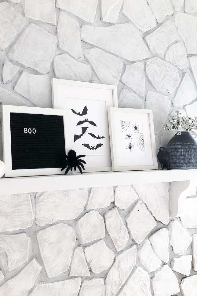 Black bats, black spiders and the word boo framed in black and white.
