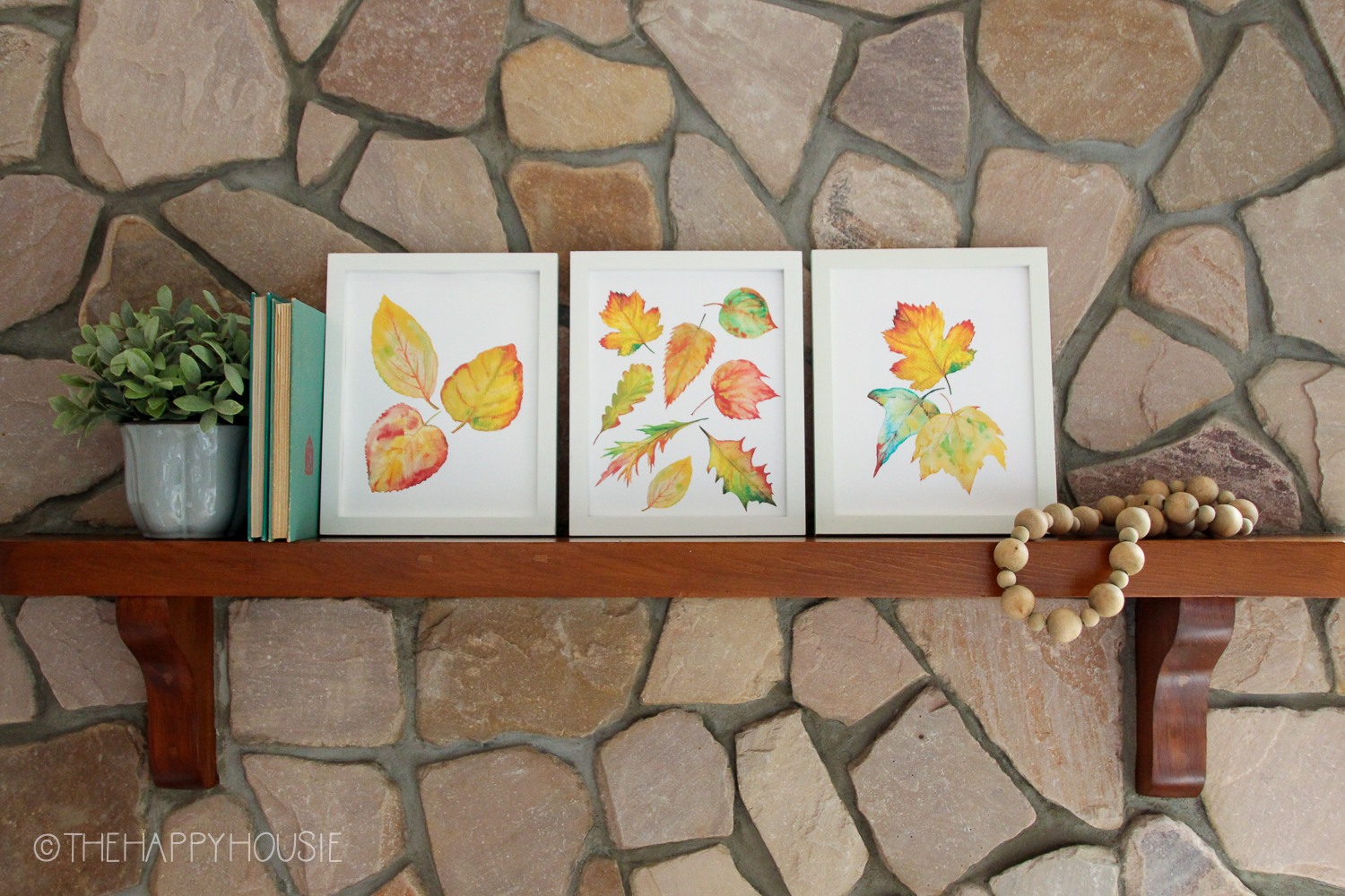 Leaf printables on the ledge above the fireplace.
