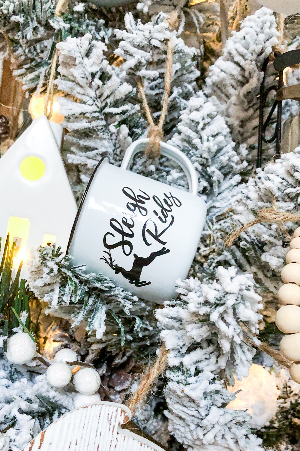 A mug that says Sleigh Ride is on the tree.