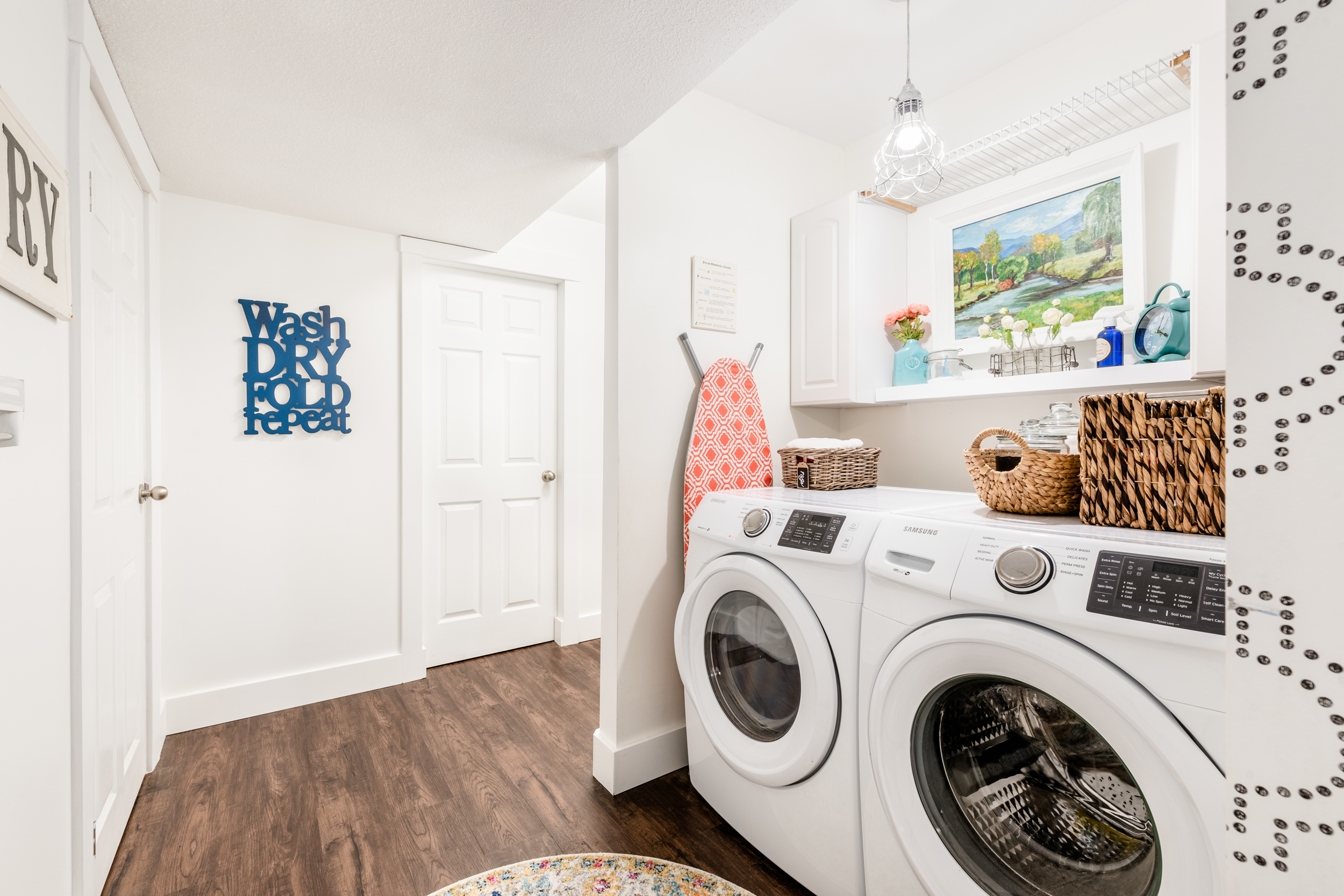 a bright and updated laundry nook just off a basement hallway