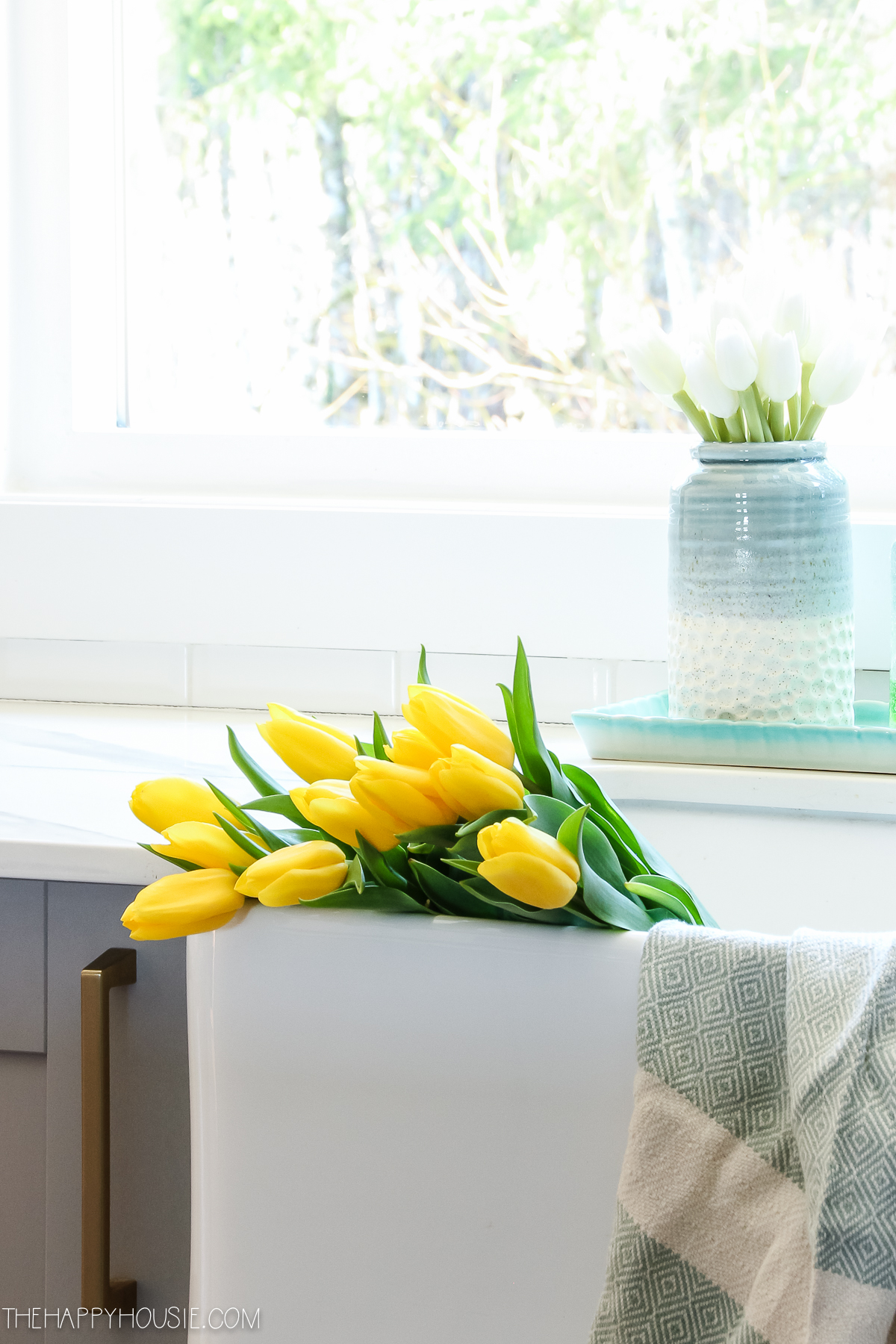 Yellow tulips in the farmhouse sink.