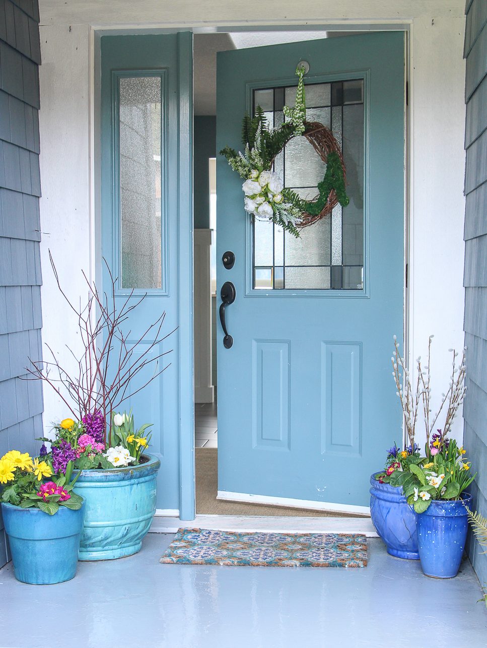 There is a light blue front door to the home ajar.