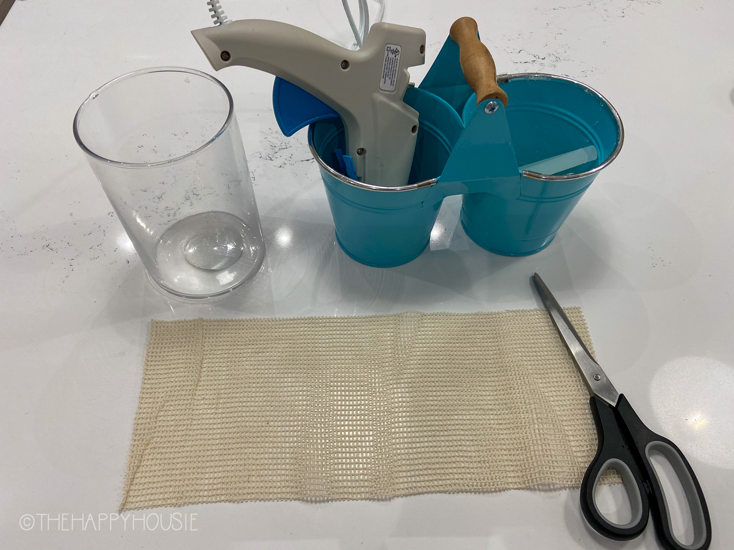 The mesh is beside the scissors and a glass.