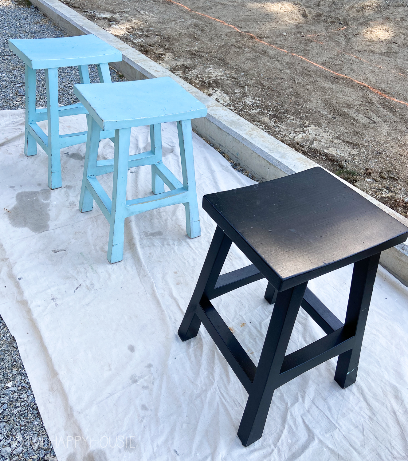 Two blue stools and one black outside.