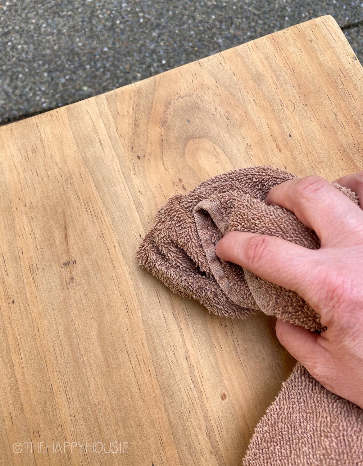 Using a cloth to buff the wood.