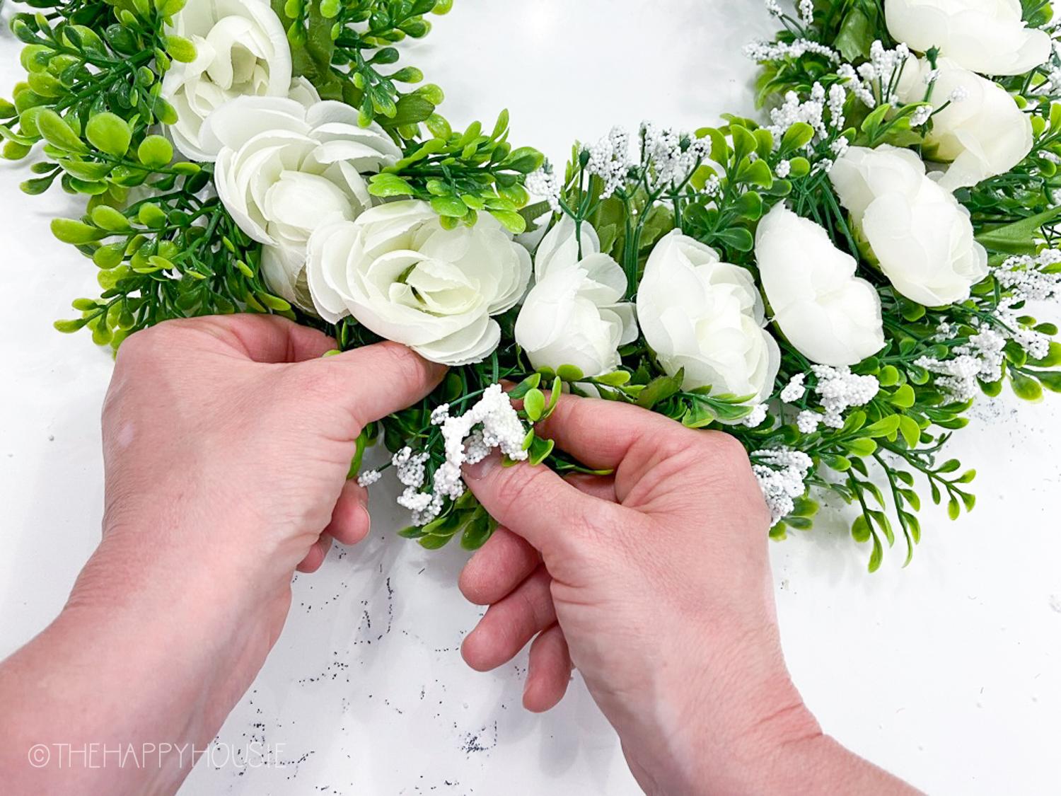 The white babys breath on the wreath.