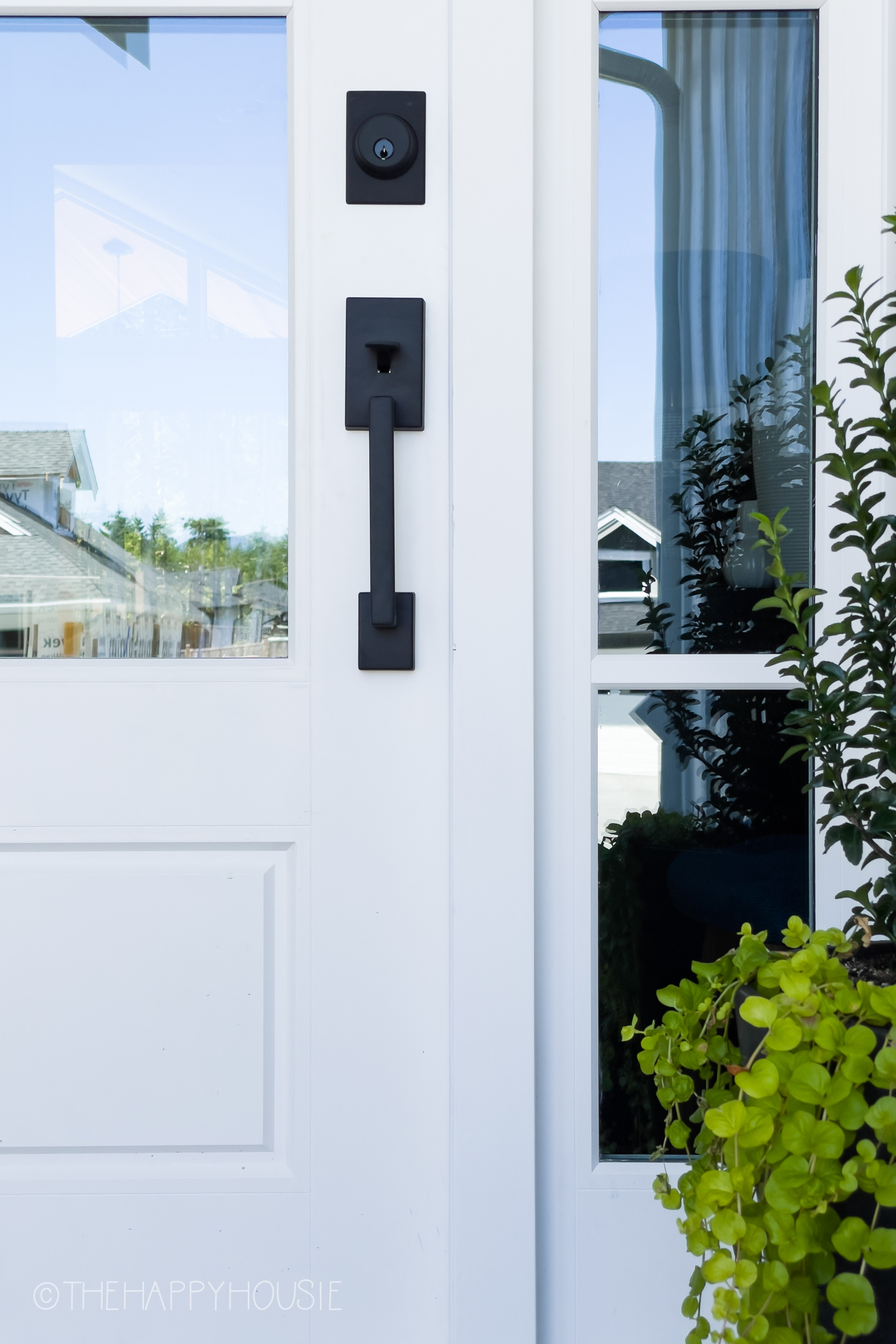 modern matte black Schlage exterior front handleset shown on a front door