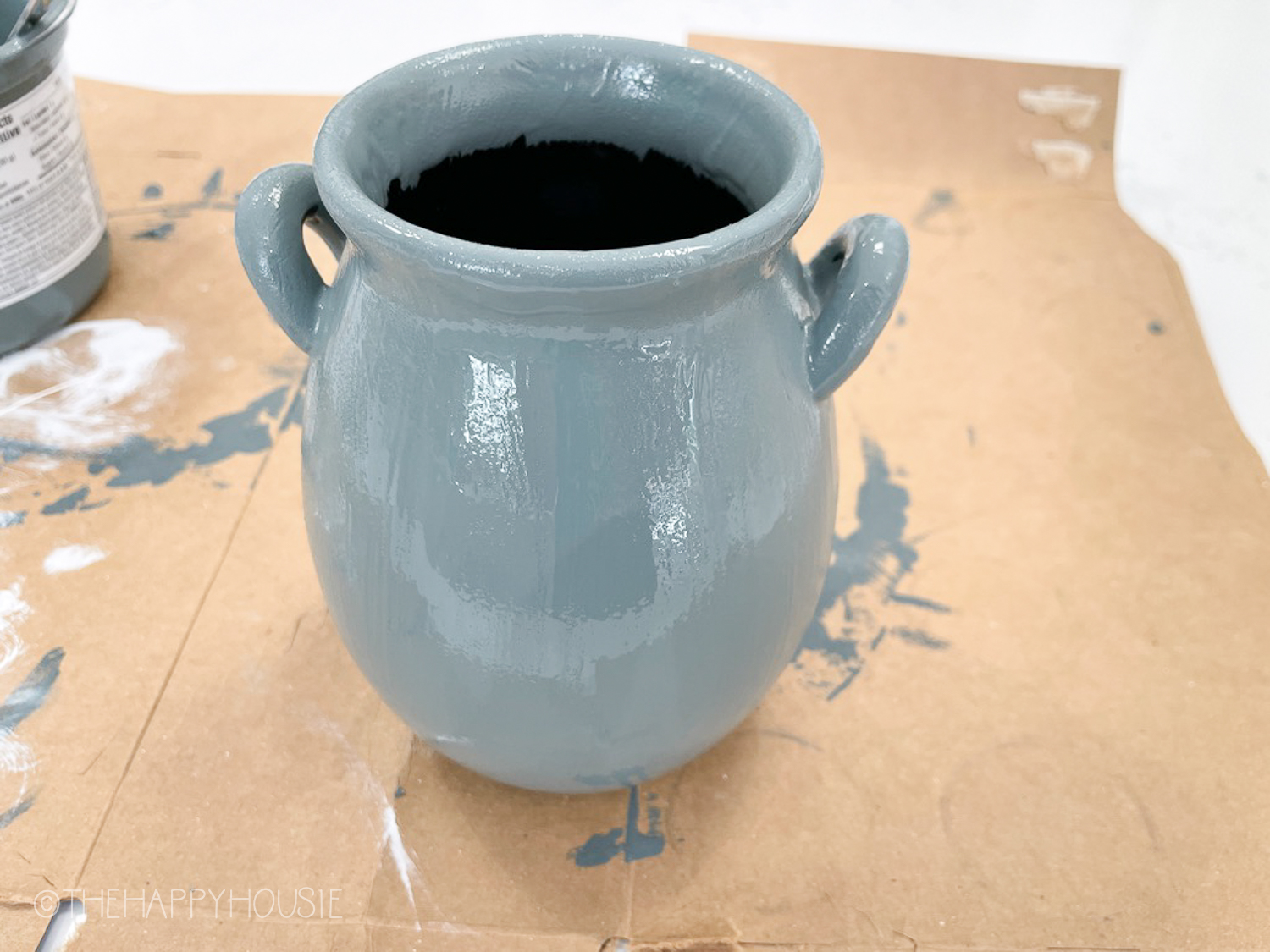 Painting one of the vases.