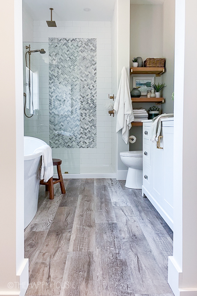 Ensuite bathroom with walk-in shower and vinyl plank floors