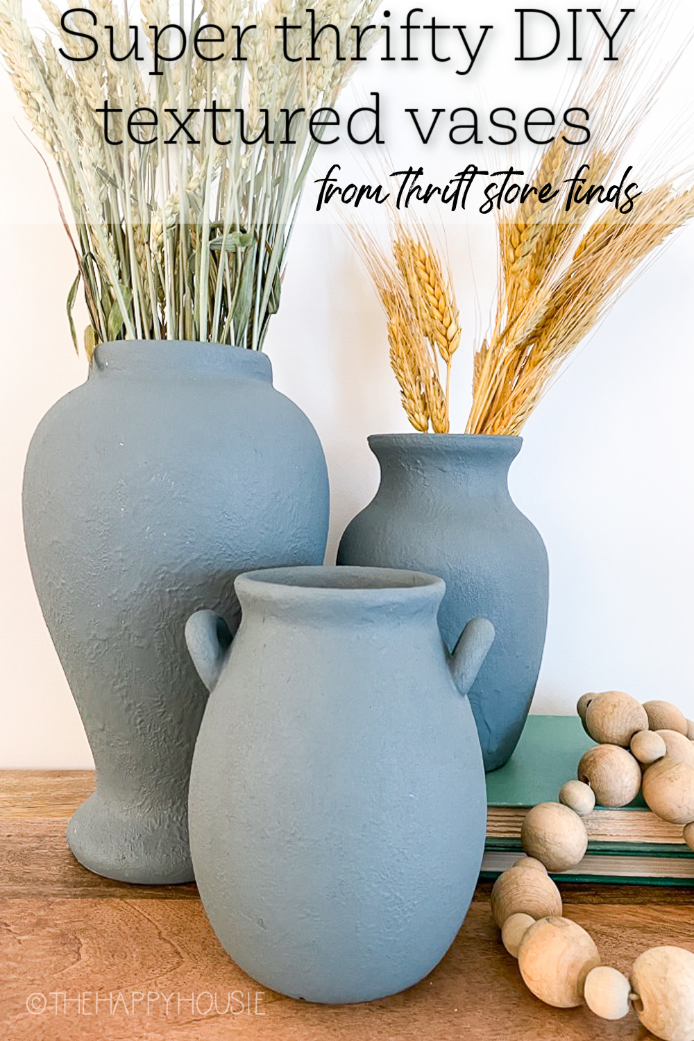 three vases that have been painted with DIY texture paint using baking soda; thrift store vases updated