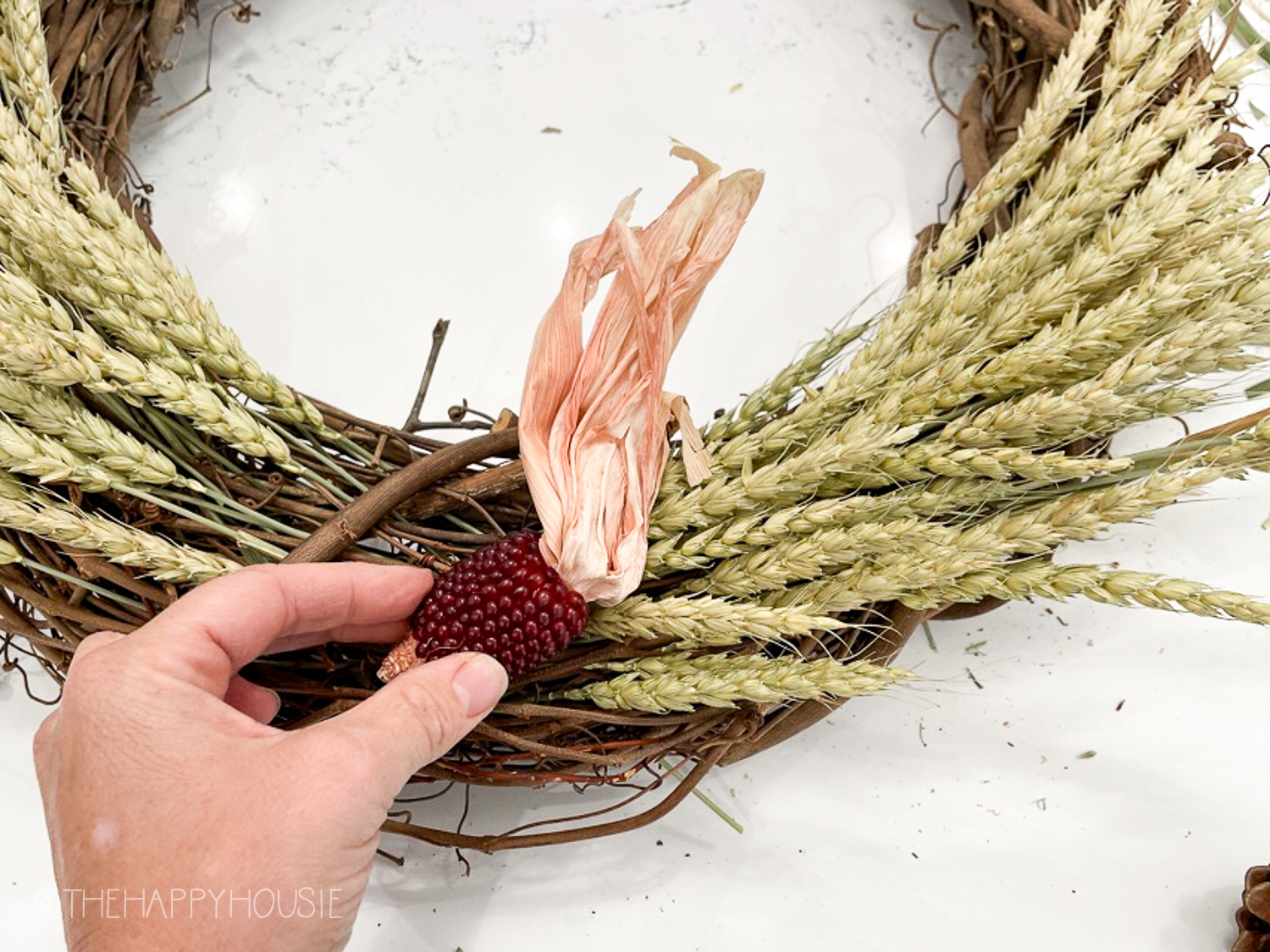 Showing how to attach the corn to the wreath.