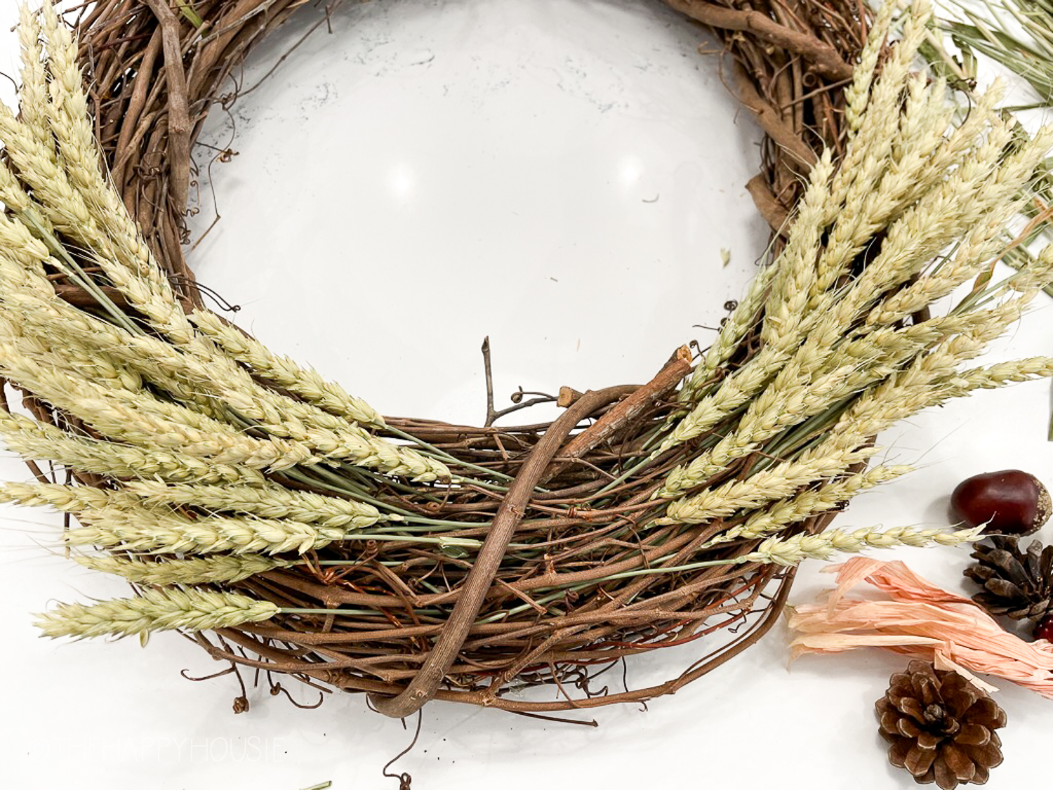 The grapevine wreath with the wheat tucked into it.