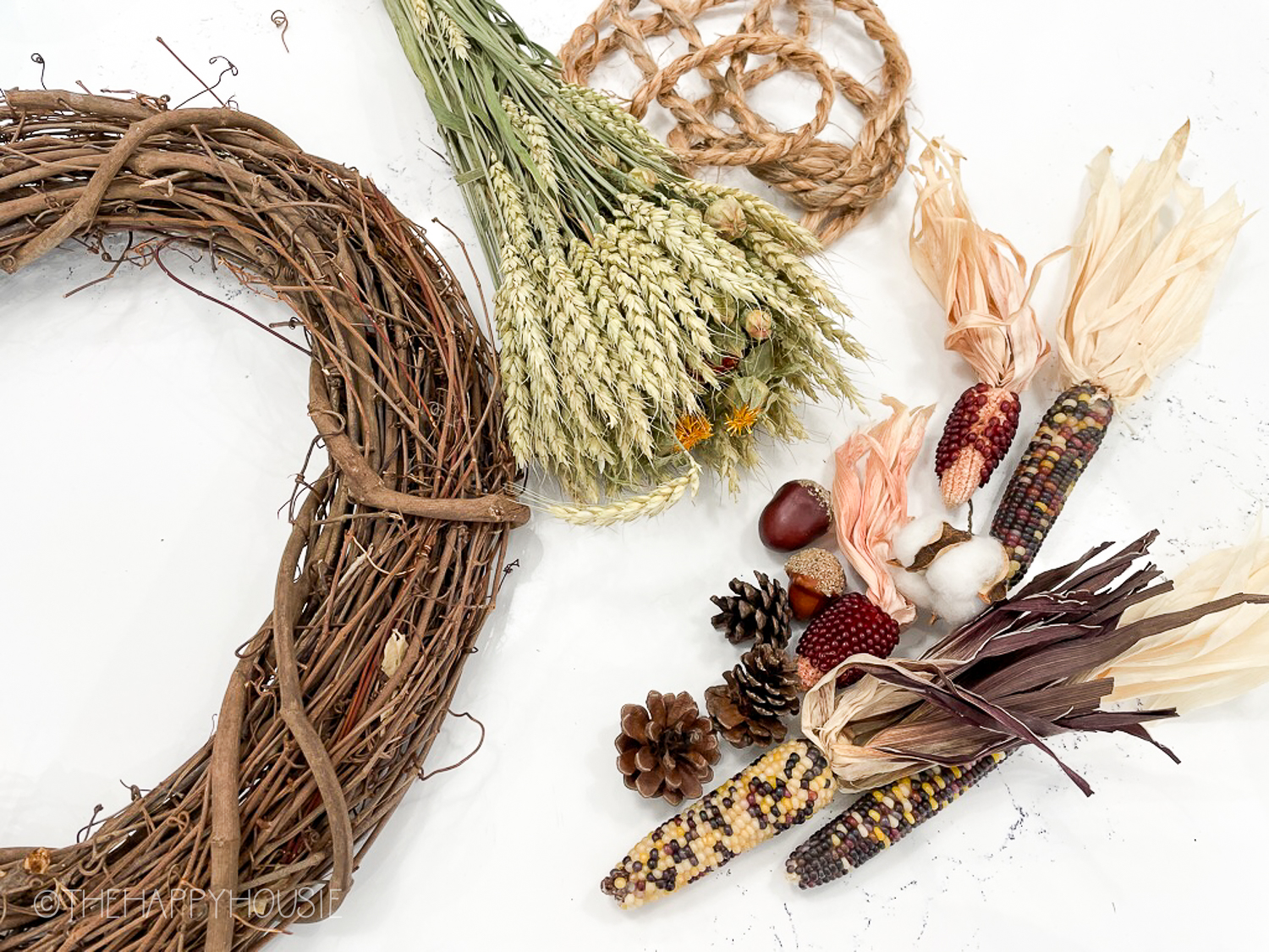 Dried corn, what grass, a wreath and twine.