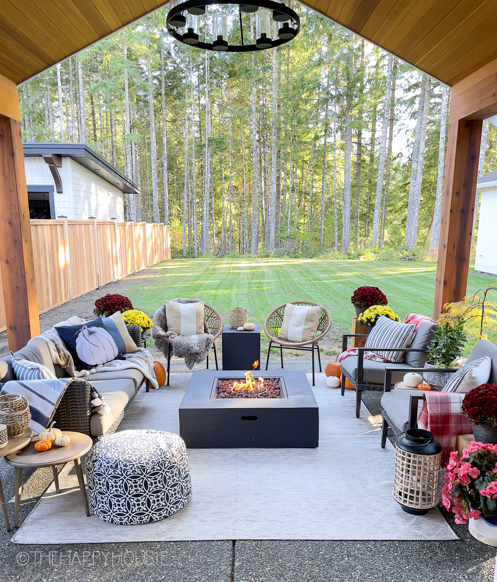 An outdoor porch area with a small firepit.
