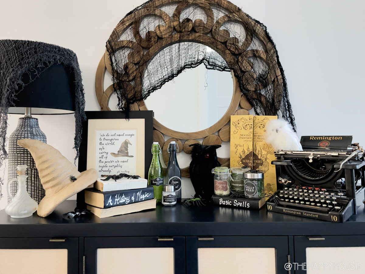 An old typewriter, a mirror with netting on it and a lamp with netting.