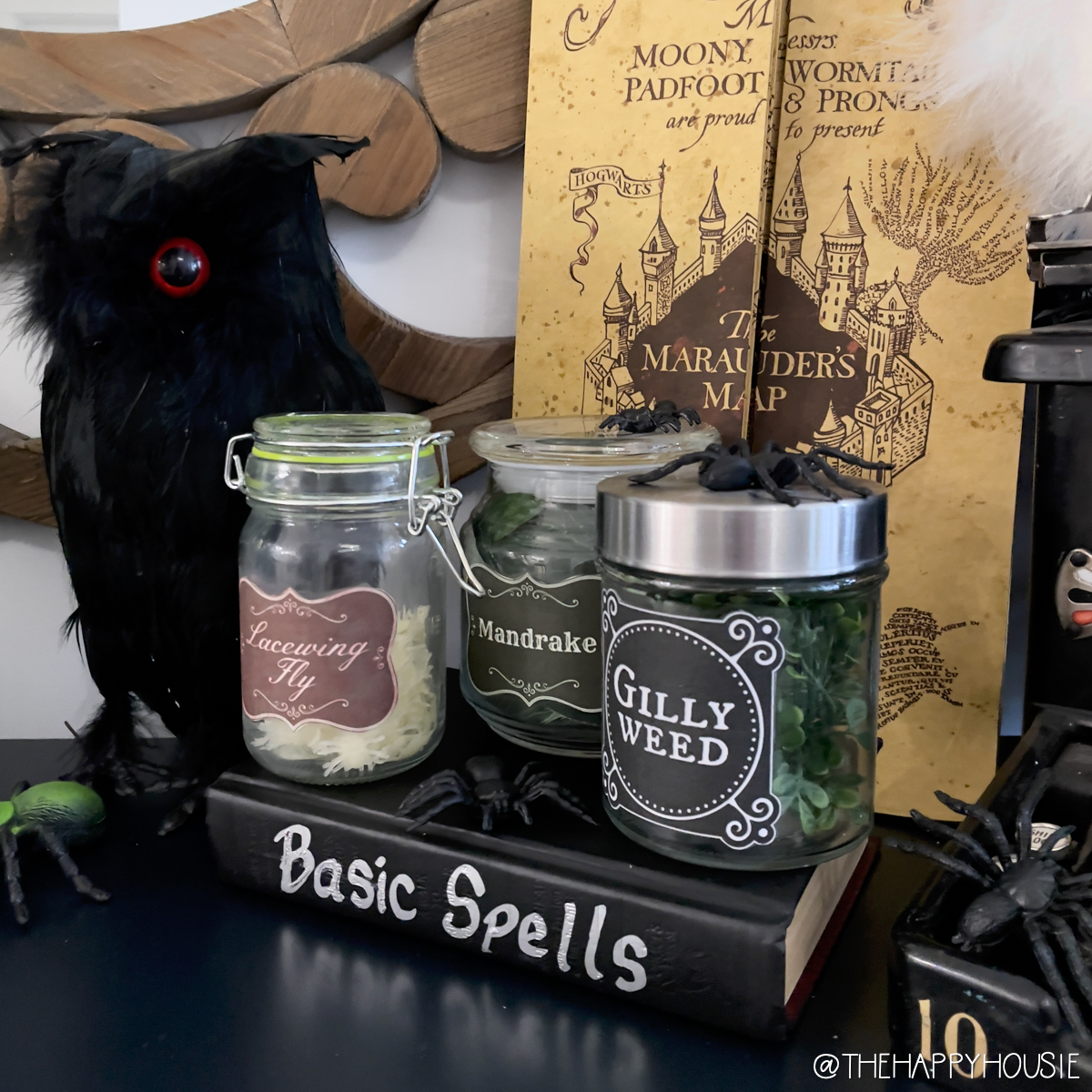 A book of basic spells has the jars sitting on top of it.