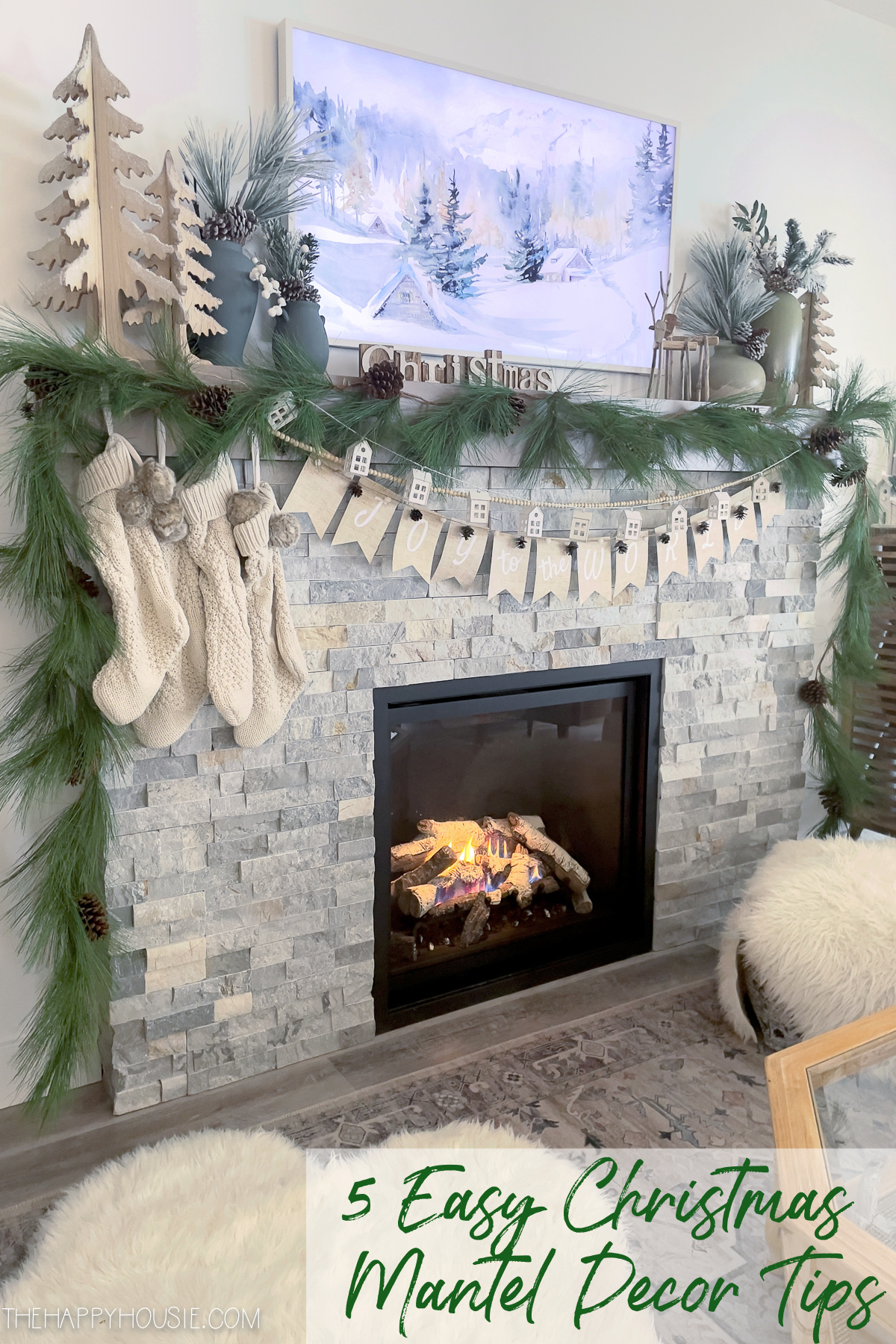A stone fireplace decorated for winter.