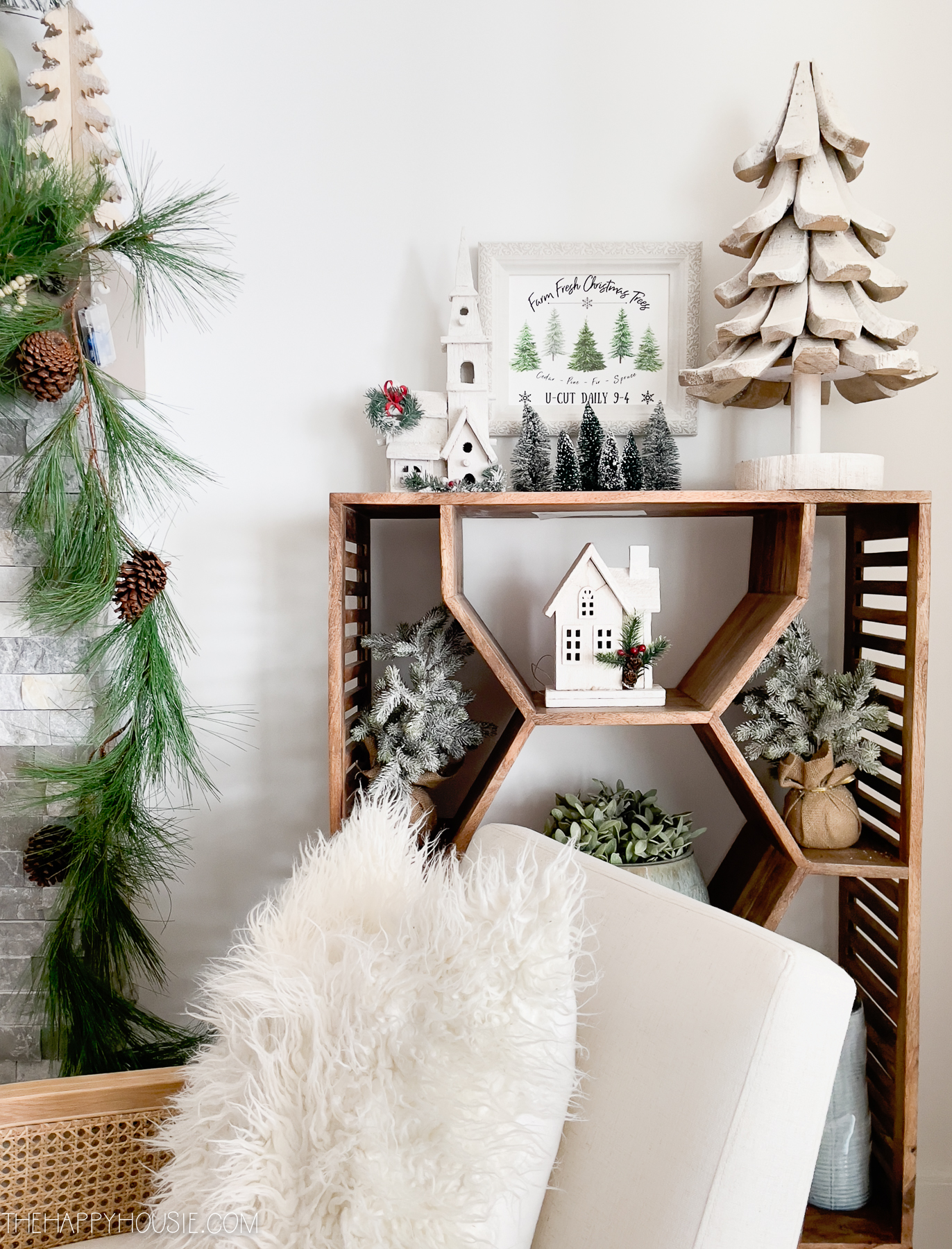 A wooden shelf with Christmas items on it.