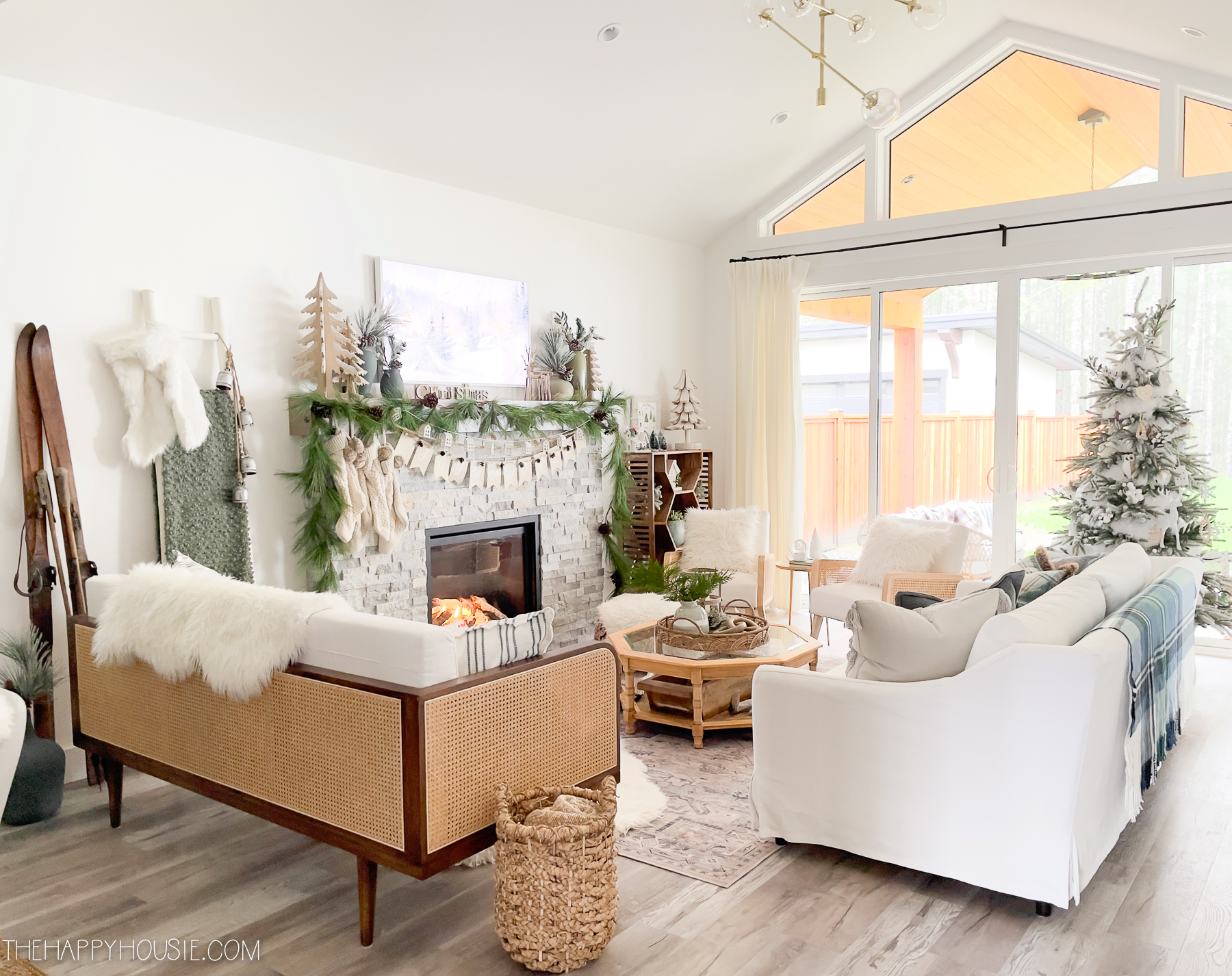 A cozy living room with white faux fur and blankets.