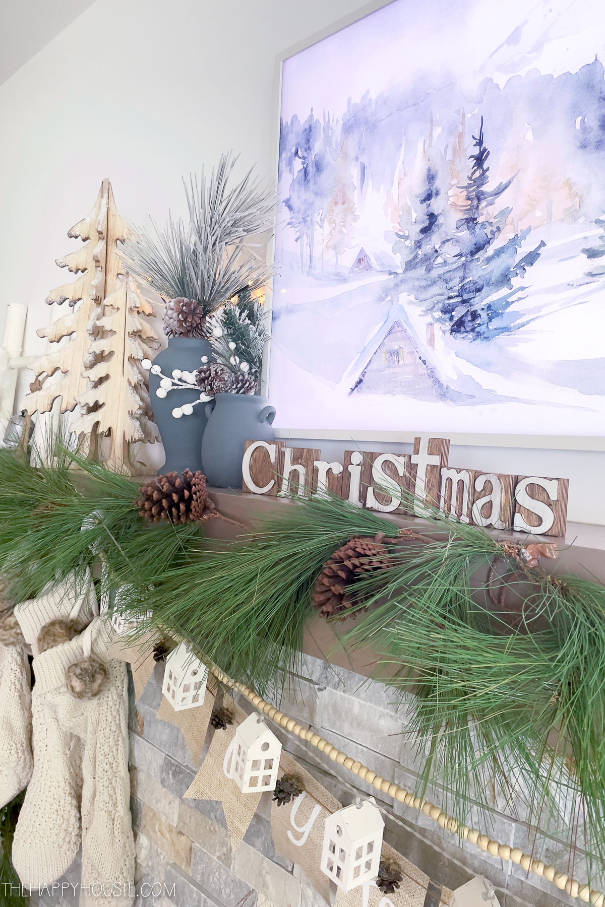 Wooden sign that says Christmas is on the mantel.