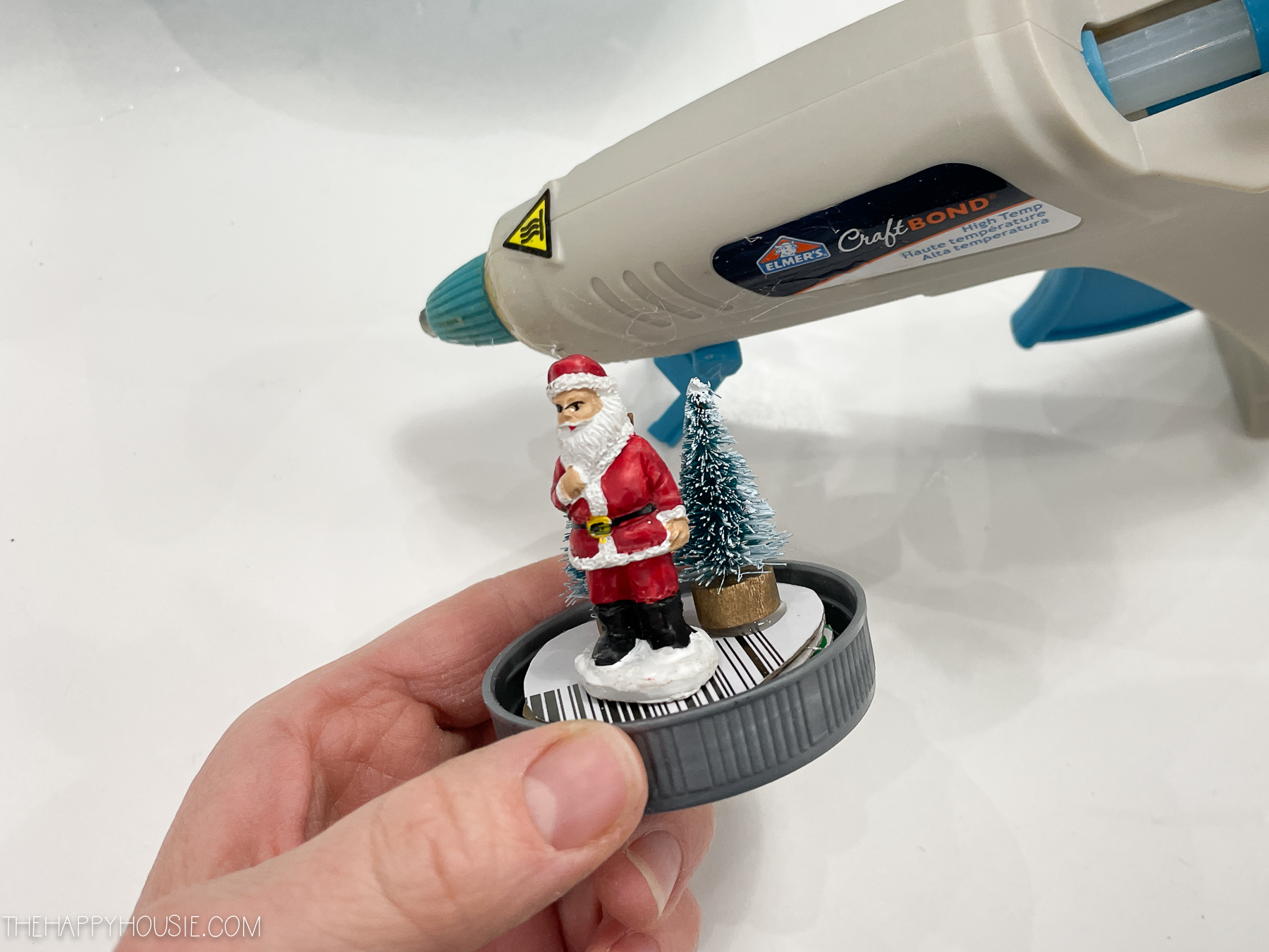 Gluing the mini Santa and tree.