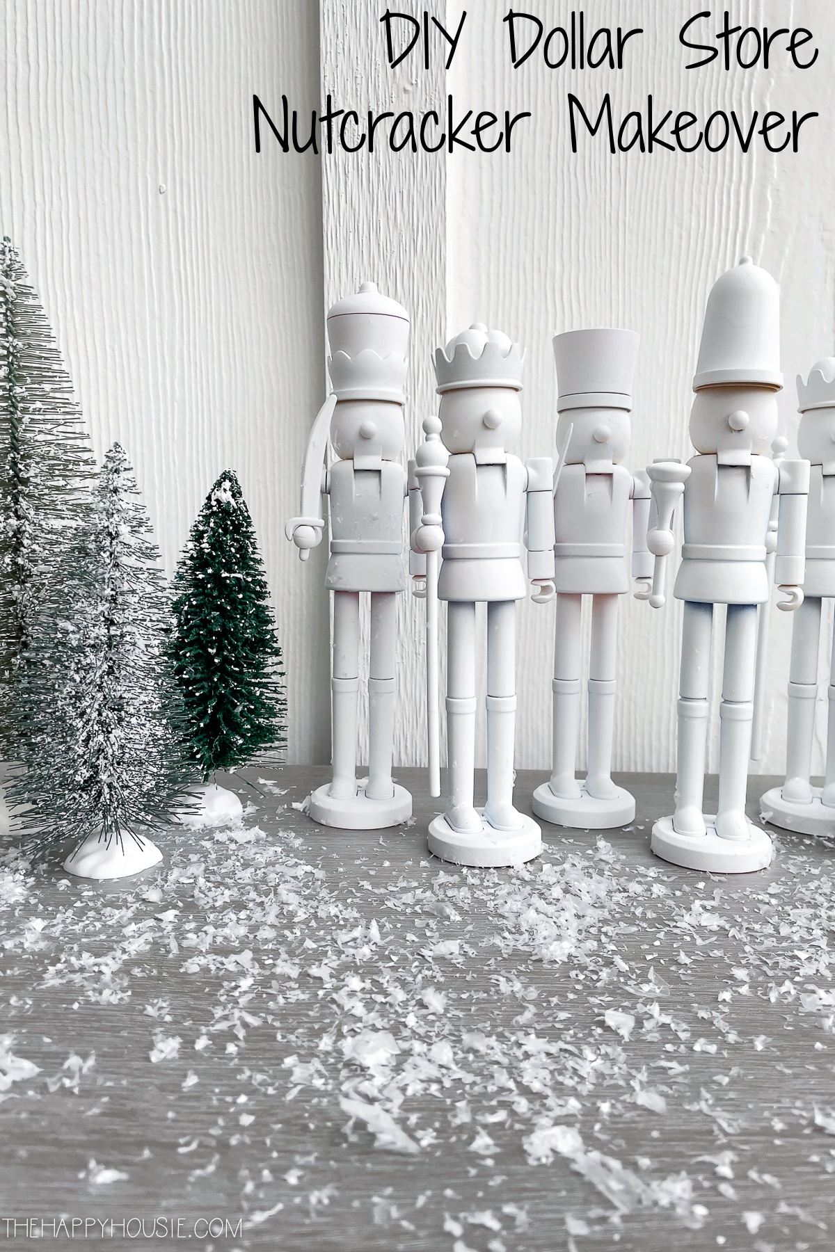The white nutcrackers lined up beside the trees.