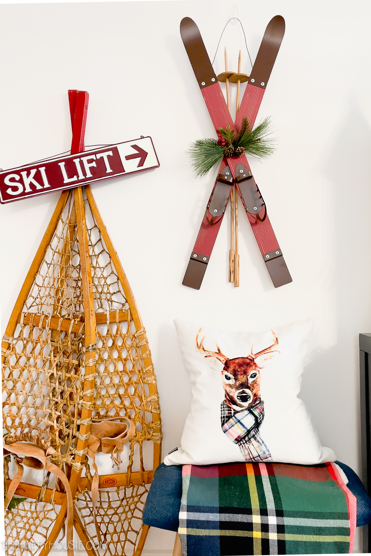 A snowshoe and skiis on the wall.